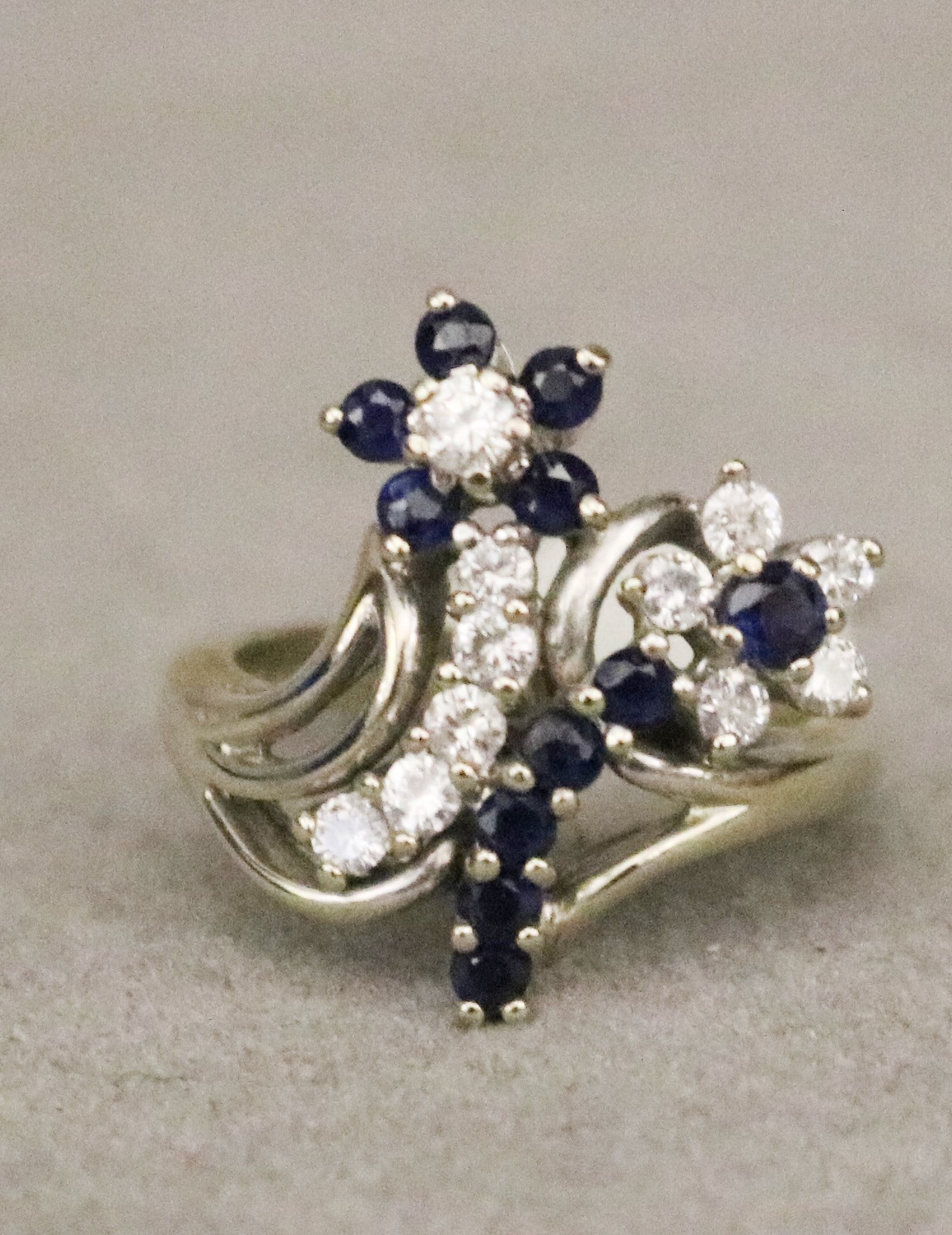 14K WHITE GOLD, DIAMOND AND SAPPHIRE FLORAL DESIGN RING Two flowerheads with stems set with 11 (1 of 3)