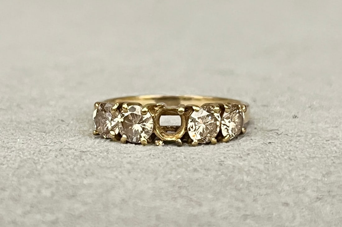 14K YELLOW GOLD AND DIAMOND BAND (MISSING CENTER) Row of four matched brilliant-cut round diamonds: 14K YELLOW GOLD AND DIAMOND BAND (MISSING CENTER) Row of four matched brilliant-cut round diamonds together weighing app. 1.00 ct. Ring size: 7 1/4 in. Gross wt. 2 dwt