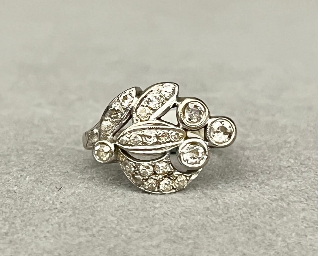 1940s 14K WHITE GOLD AND DIAMOND LEAF-AND-BERRY DESIGN RING 22 graduated Old Mine cut diamonds in: 1940s 14K WHITE GOLD AND DIAMOND LEAF-AND-BERRY DESIGN RING 22 graduated Old Mine cut diamonds in horizontally-oriented stylized leaf-and-berry cluster Ring size: 5 3/4. Gross wt. 3 dwt.