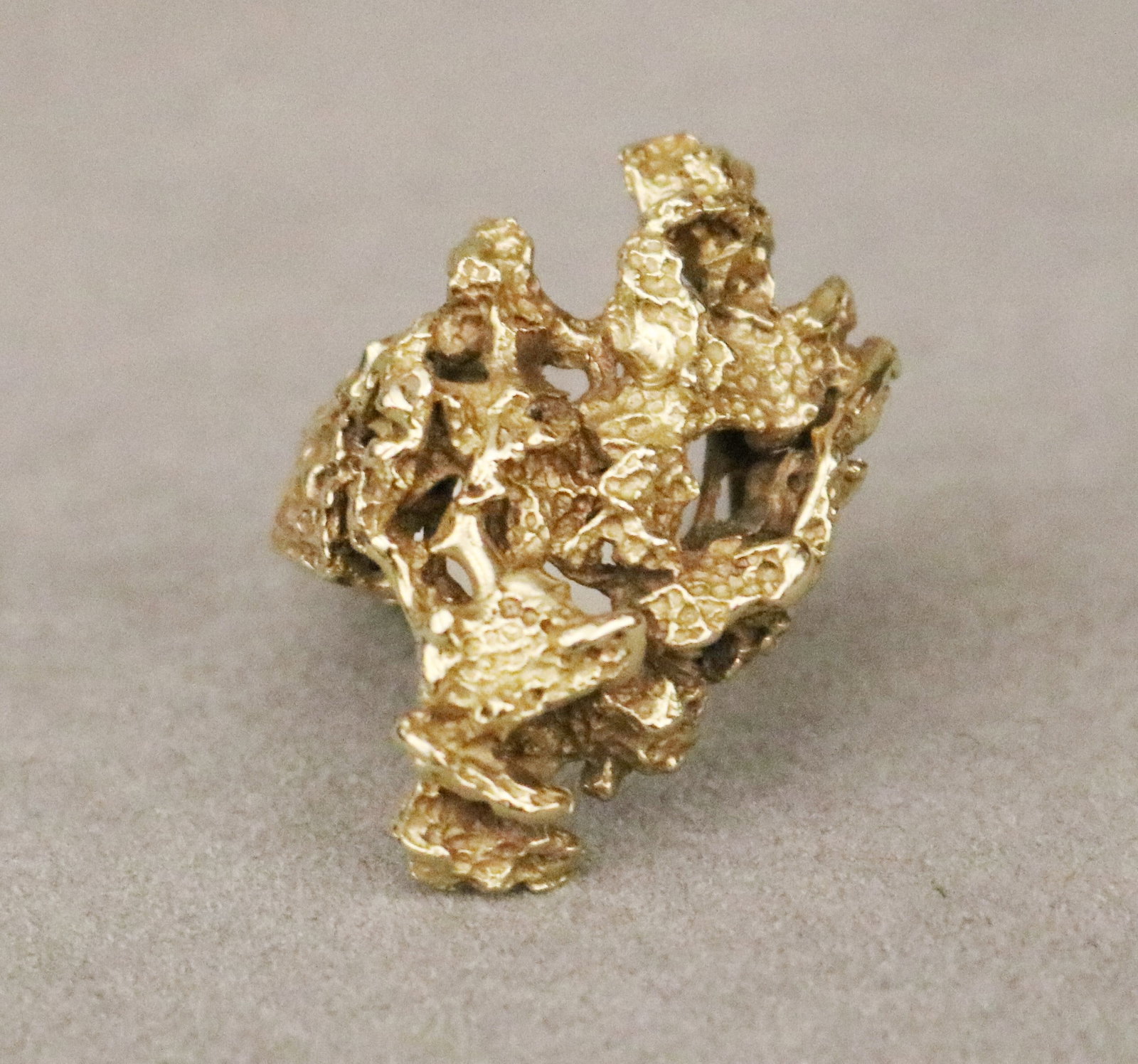 18K YELLOW GOLD NUGGET-TEXTURED ASYMETRICAL OPENWORK RING Ring size: 7 1/2. Wt. 10 dwt.: 18K YELLOW GOLD NUGGET-TEXTURED ASYMETRICAL OPENWORK RING Ring size: 7 1/2. Wt. 10 dwt.
