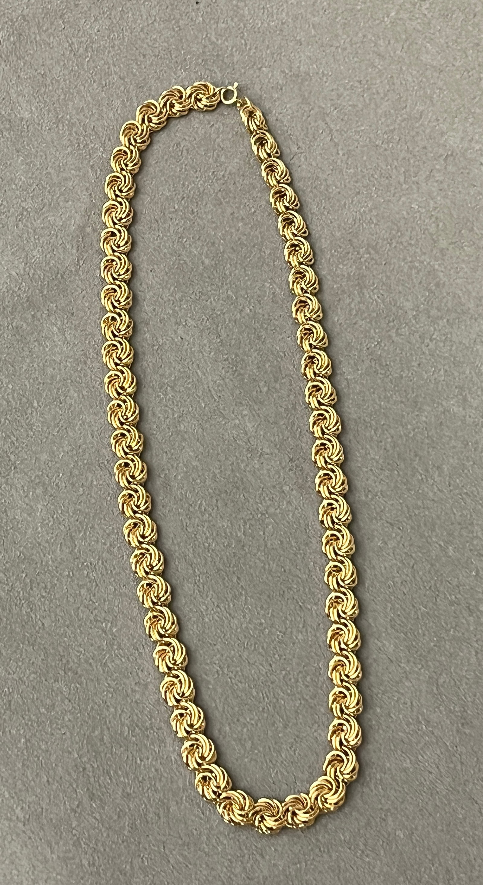 14K BRIGHT-POLISHED YELLOW GOLD FLEXIBLE-LINK CHOKER Openwork spiraling circular links. L: 18".: 14K BRIGHT-POLISHED YELLOW GOLD FLEXIBLE-LINK CHOKER Openwork spiraling circular links. L: 18". W: 5/16". Wt: 14 dwt.