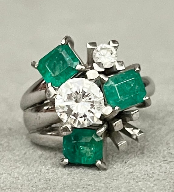 14K WHITE GOLD, DIAMOND AND EMERALD RING Brilliant-cut round diamond weighing approximately 1.00: 14K WHITE GOLD, DIAMOND AND EMERALD RING Brilliant-cut round diamond weighing approximately 1.00 ct. raised and centered by three emerald-cut emeralds each weighing approximately .50 ct., and one bril