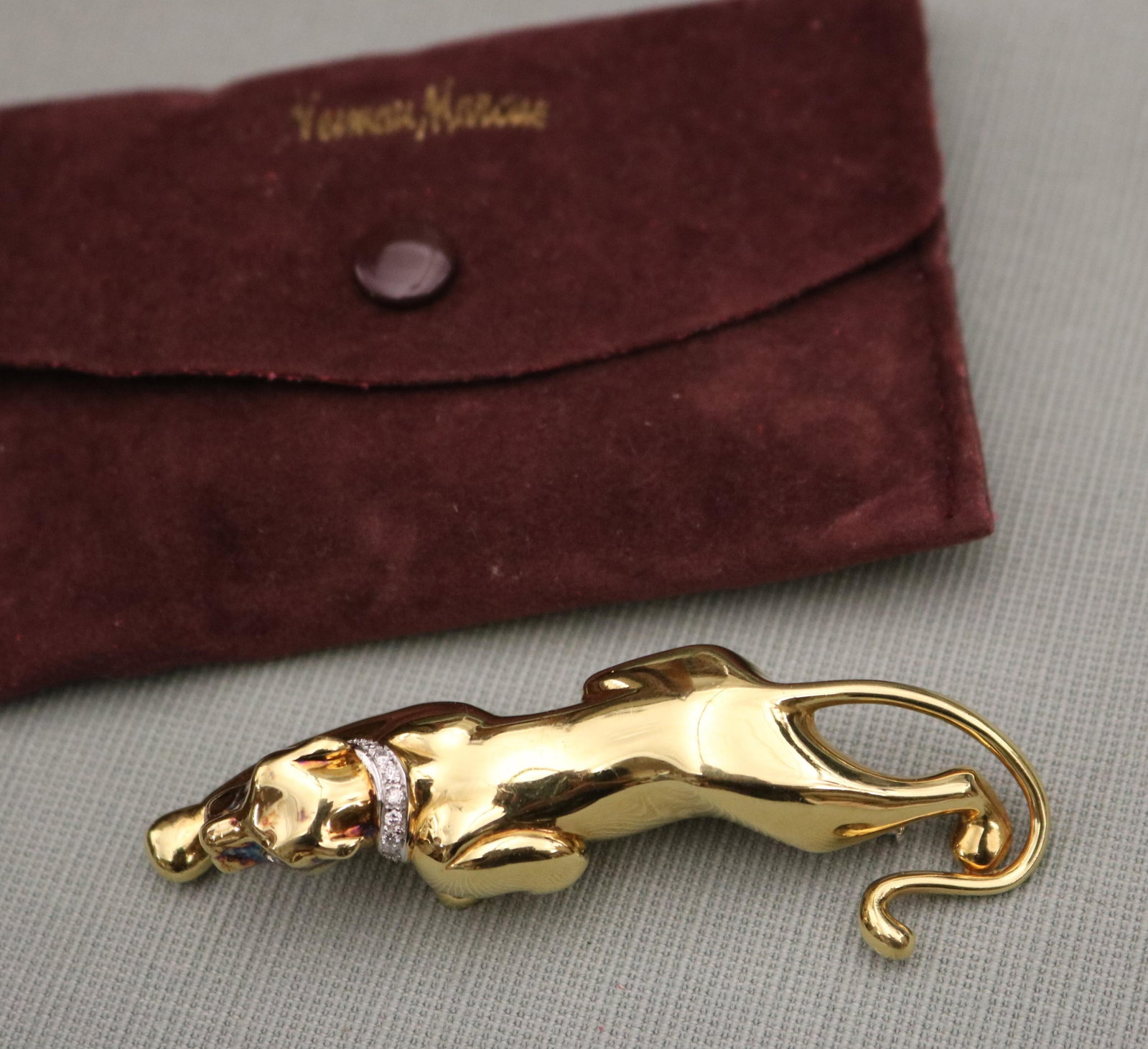 ITALIAN 18K YELLOW AND WHITE GOLD AND DIAMOND "PROWLING PANTHER" BROOCH Bright-polished yellow: ITALIAN 18K YELLOW AND WHITE GOLD AND DIAMOND "PROWLING PANTHER" BROOCH Bright-polished yellow gold panther with diamond eyes, has white gold collar set with channel of ten matched, brilliant-cut roun
