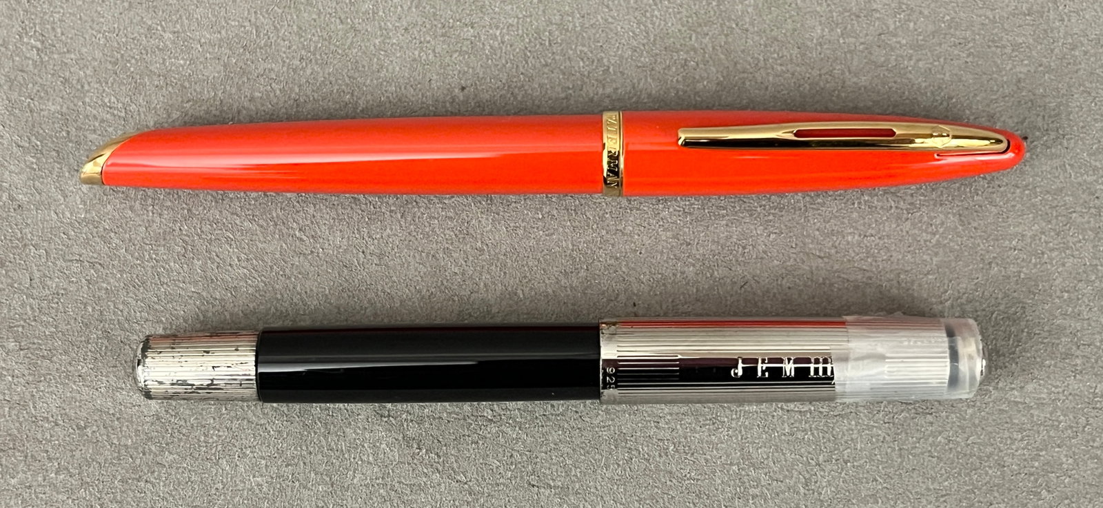 TWO VINTAGE FOUNTAIN PENS One, Waterman, made in France, with orange-red lacquer barrel and 18K (1 of 2)