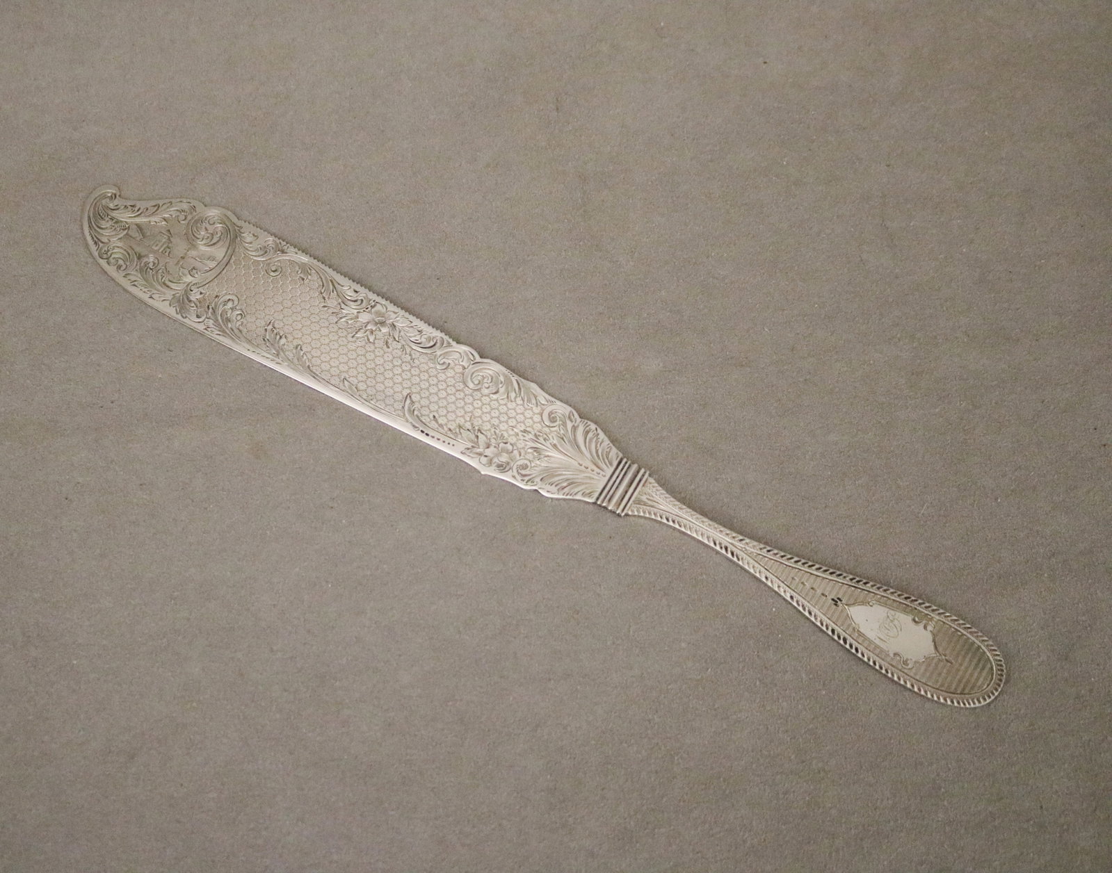 COIN SILVER FISH KNIFE BY BECHTEL & ENO mid 19th century - L: 11 1/2 in. Wt. 2.6 troy oz..: COIN SILVER FISH KNIFE BY BECHTEL & ENO mid 19th century Chased decoration; monogrammed. In presentation box L: 11 1/2 in. Wt. 2.6 troy oz.