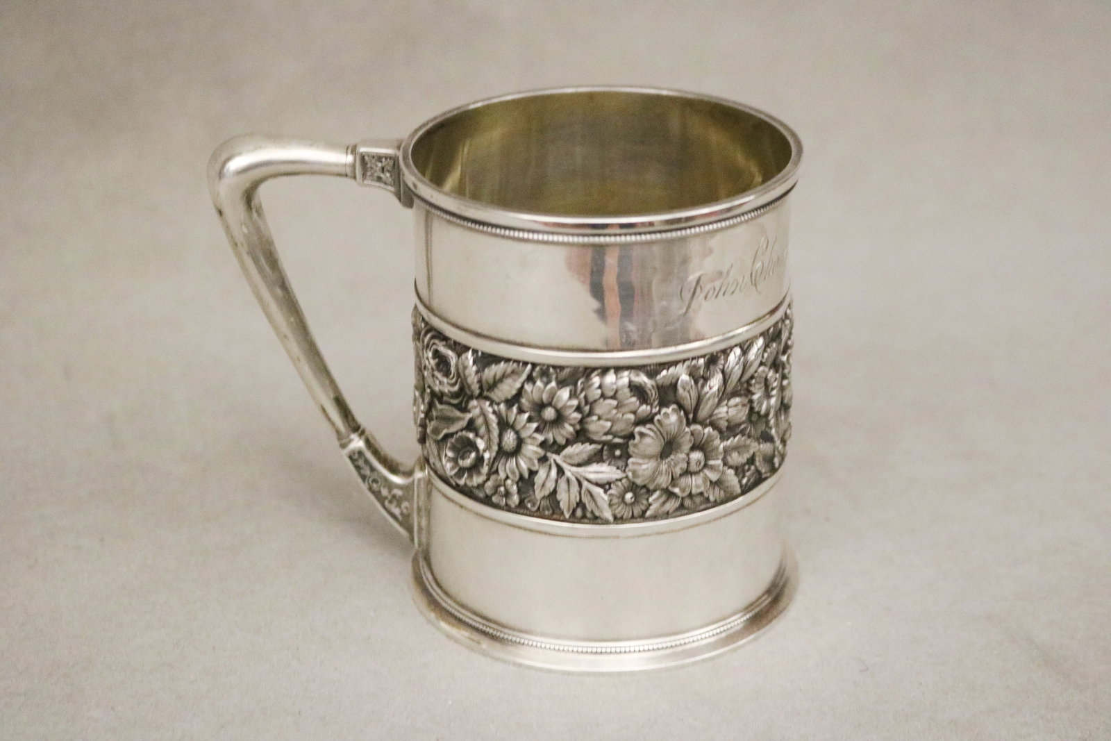 WM. WILSON & SON STERLING SILVER CYLINDRICAL CUP WITH FRIEZE AND OF FLORAL REPOUSSE DECORATION - H:: WM. WILSON & SON STERLING SILVER CYLINDRICAL CUP WITH FRIEZE AND OF FLORAL REPOUSSE DECORATION Engraved. H: 3 3/8 in. Wt. 5.2 troy oz.