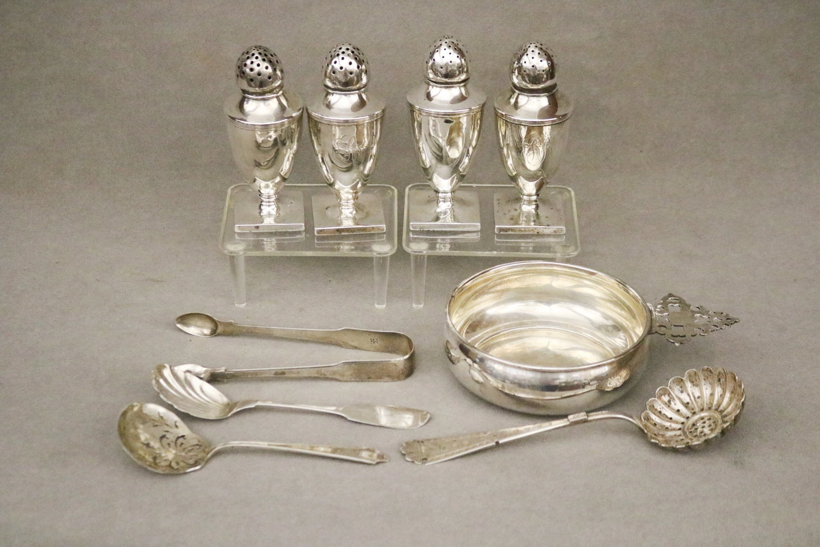 NINE ASSORTED SILVER AND STERLING SILVER TABLE ARTICLES 19th and 20th century - Wt. 18 troy oz..: NINE ASSORTED SILVER AND STERLING SILVER TABLE ARTICLES 19th and 20th century Wallace Co. porringer; set of four urn-form salt and pepper shakers; George III sugar tongs by William Eley and William
