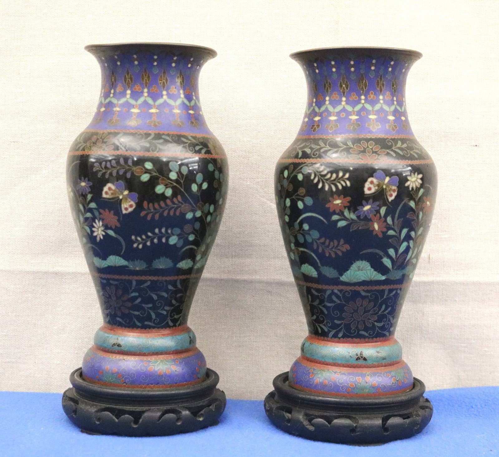 PAIR OF JAPANESE MEIJI PERIOD (1868?1912) CLOISONNE VASES BALUSTER-FORM VASES Meiji period - Each,: PAIR OF JAPANESE MEIJI PERIOD (1868?1912) CLOISONNE VASES BALUSTER-FORM VASES Meiji period black central register enclosing naturalistic sprays of chrysanthemum, prunus, and other flowering branches w