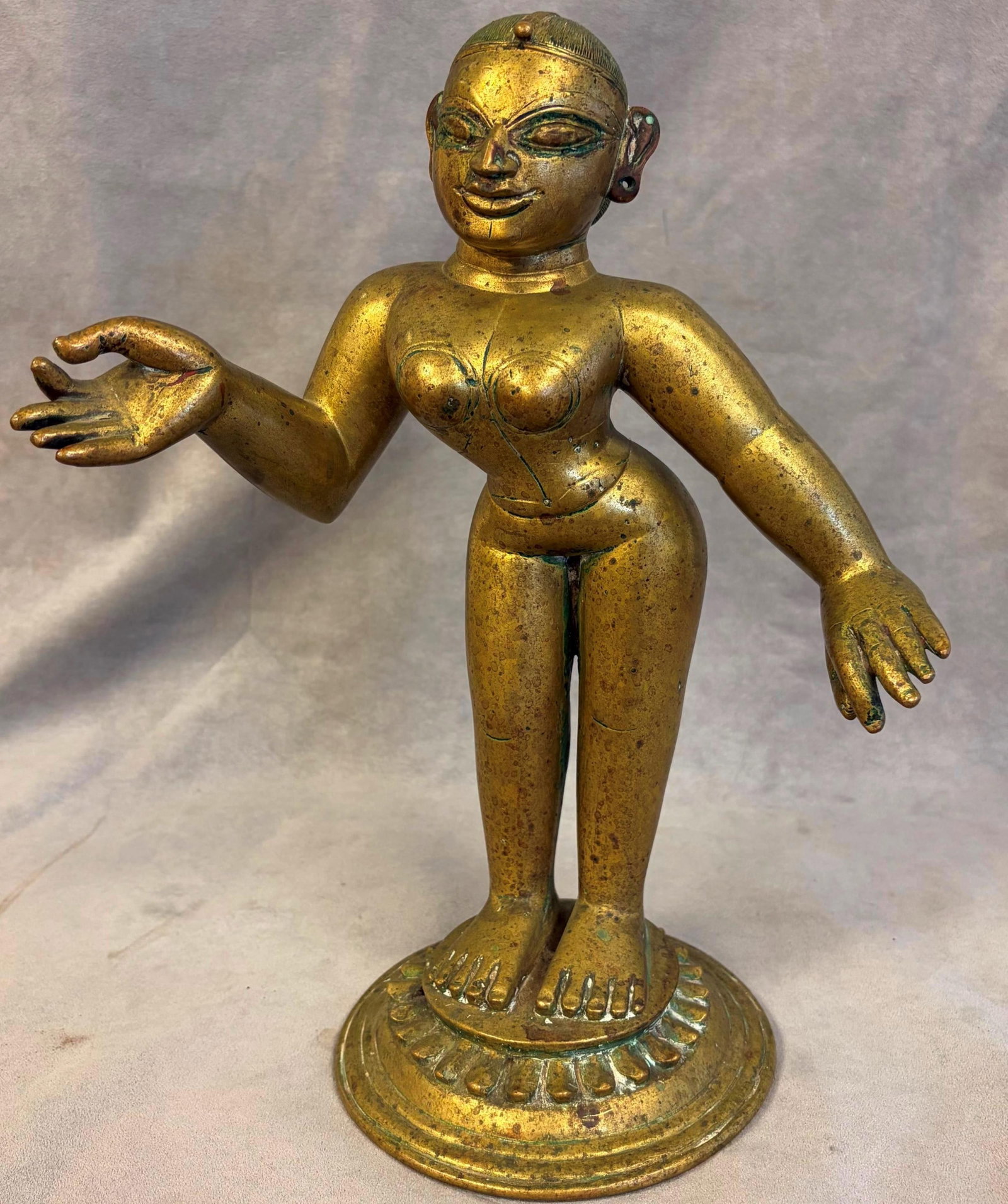 BRASS FIGURE OF RADHA FROM INDIA'S BENGAL OR ORISSA (ODISHA) REGIONS Mid-to-late 19th century -: BRASS FIGURE OF RADHA FROM INDIA'S BENGAL OR ORISSA (ODISHA) REGIONS Mid-to-late 19th century Patinated brass figure of the Hindu goddess Radha, standing on a lotus-form base with both arms gracefully