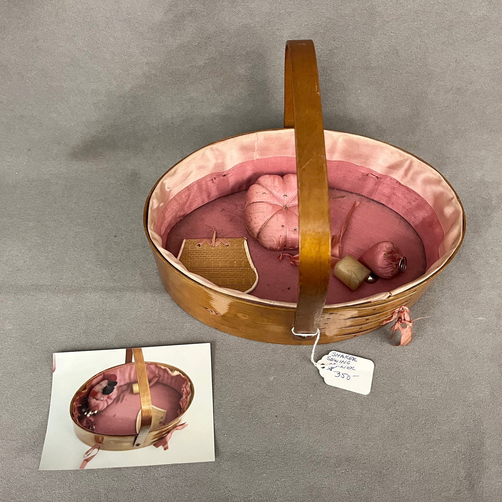 SHAKER OVAL SEWING CARRIER WITH BAIL HANDLE - Basket, 9 1/4 in. x 6 1/8 in..: SHAKER OVAL SEWING CARRIER WITH BAIL HANDLE Lined with pink silk. With needlecase, pin cushion and weight. Basket, 9 1/4 in. x 6 1/8 in.