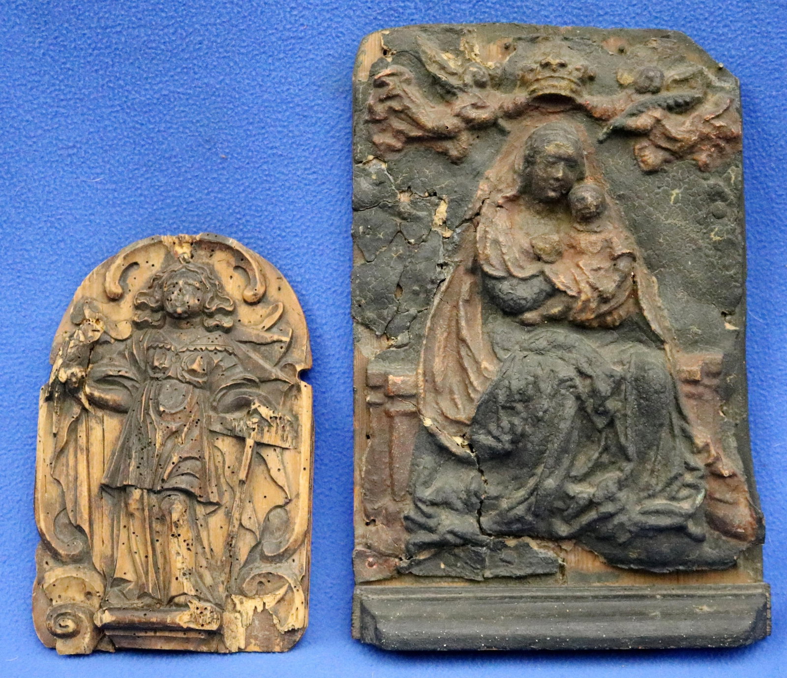PAIR OF CONTINENTAL RELIGIOUS RELIEFS 19th century - Large relief: 12 x 9 inches.: PAIR OF CONTINENTAL RELIGIOUS RELIEFS 19th century Pair of heavily weathered continental reliefs mounted on a modern board. The larger panel (right) features a Gothic Madonna and Child. The smaller, a
