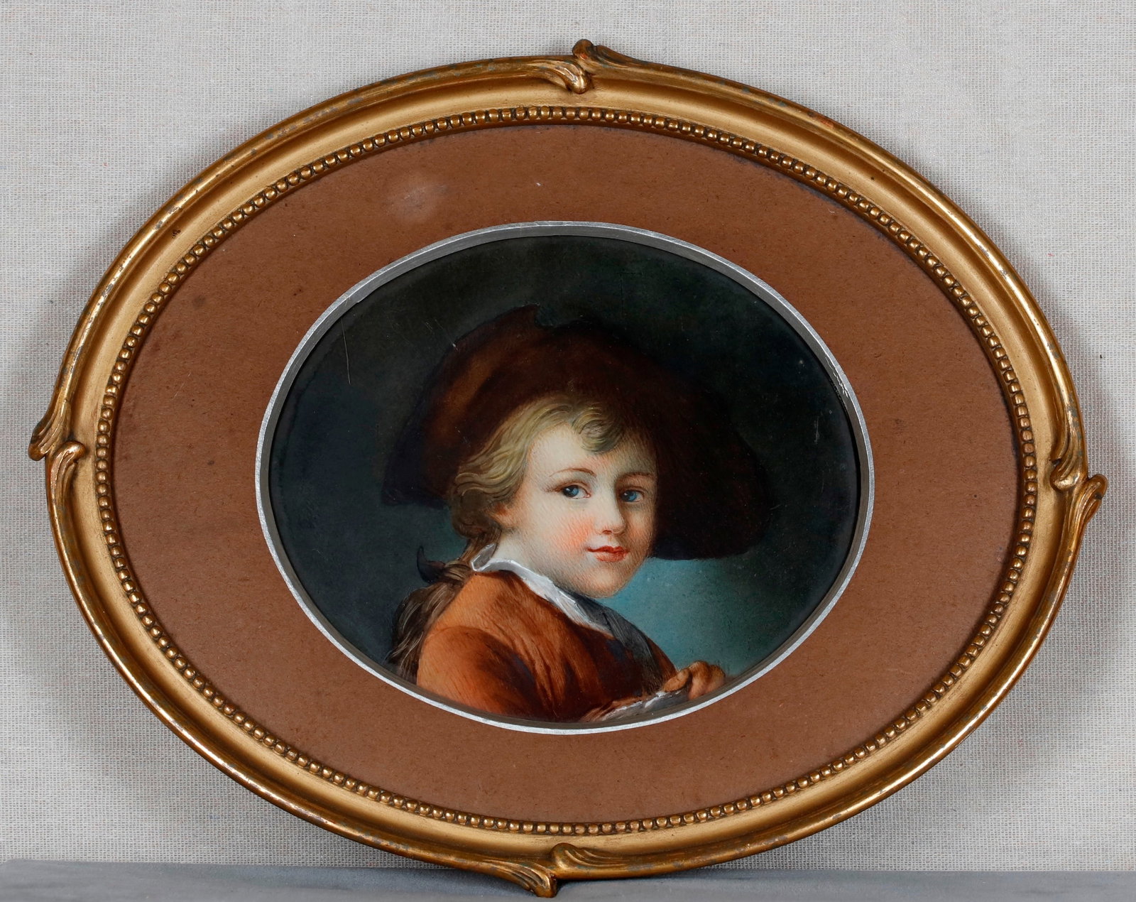 "THE YOUNG STUDENT" (LE JEUNE ELEVE); HAND-PAINTED PORCELAIN OVAL PANEL AFTER FRANCOIS-HUBERT: "THE YOUNG STUDENT" (LE JEUNE ELEVE); HAND-PAINTED PORCELAIN OVAL PANEL AFTER FRANCOIS-HUBERT DROUAIS 19th century Sight (as matted): 6 1/2 in. x 7 1/4 in.; frame: 11 in. x 13 1/4 in.