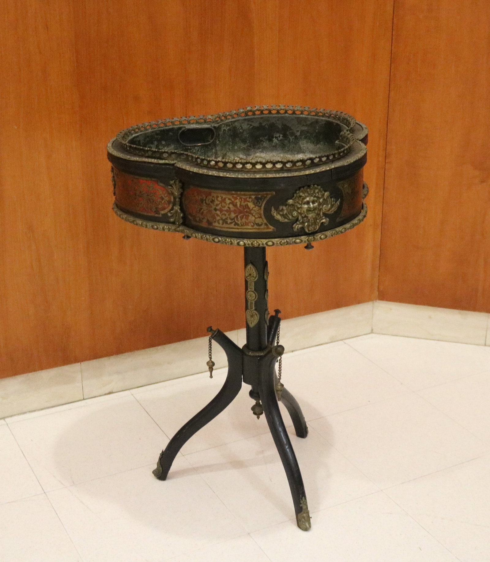 NAPOLEON III BOULE-INLAID TREFOIL-TOP, PEDESTAL-BASE PLANT STAND - H: 29 in. Top, 19 in. x 19 in..: NAPOLEON III BOULE-INLAID TREFOIL-TOP, PEDESTAL-BASE PLANT STAND Relief brass mark motifs alternate with boule-inlaid frieze panels; removable metal liner H: 29 in. Top, 19 in. x 19 in.