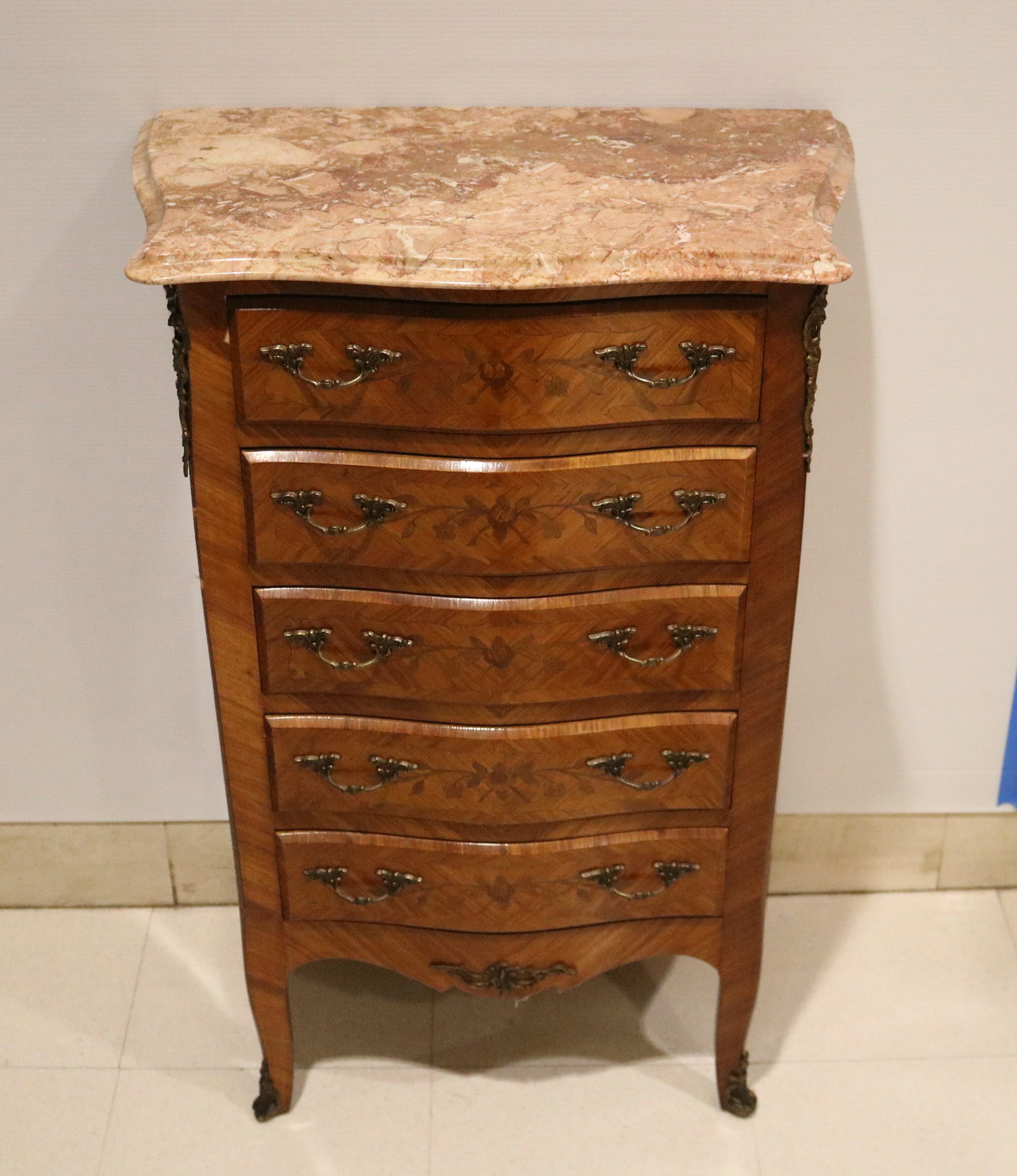 FRENCH FLORAL MARQUETRY-INLAID FIVE-DRAWER CHEST WITH MARBLE TOP - H: 34 1/2 in. W: 23 1/8 in. D: 13: FRENCH FLORAL MARQUETRY-INLAID FIVE-DRAWER CHEST WITH MARBLE TOP Pink, beige and cream shaped marble top projects over bank of five drawers with serpentine fronts. H: 34 1/2 in. W: 23 1/8 in. D: 13 1/