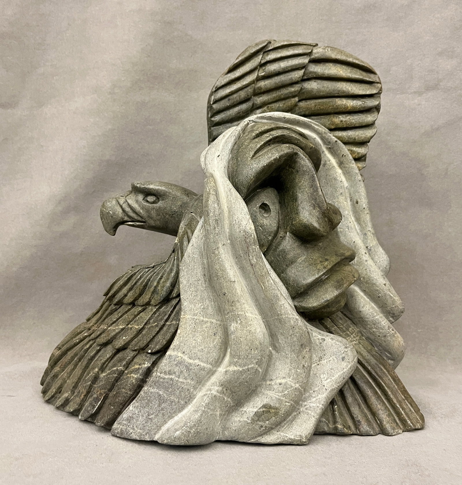 DELL WARNER (Inuit, 1952-2003). CARVING OF EAGLE/FACE OF MAN, Carved soapstone, H: 12 in. (1 of 10)