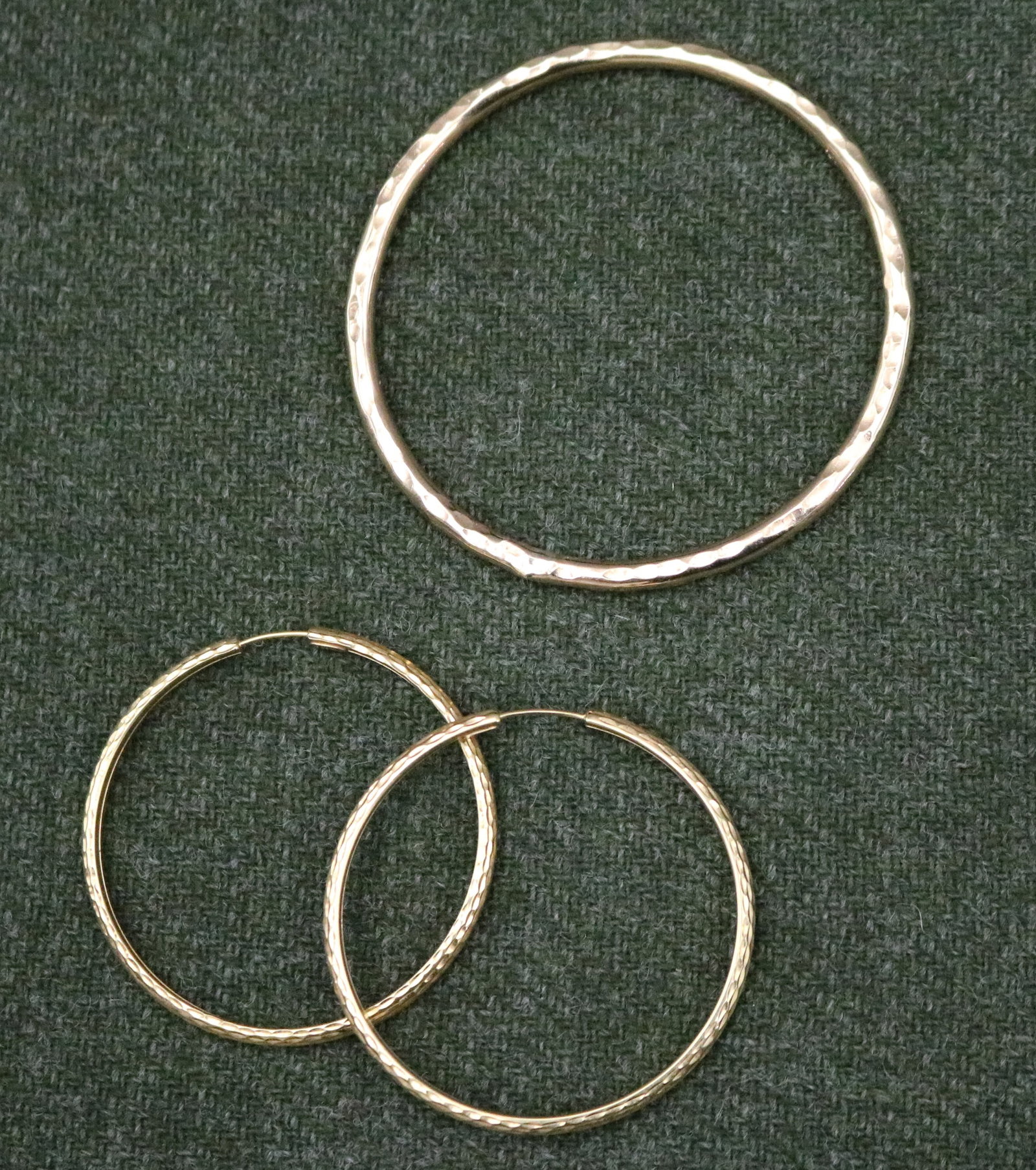 PAIR 18K BRIGHT-CUT YELLOW GOLD HOOP EARRINGS AND A GOLD-FILLED CIRCULAR SLIP-ON BANGLE BRACELET - .: PAIR 18K BRIGHT-CUT YELLOW GOLD HOOP EARRINGS AND A GOLD-FILLED CIRCULAR SLIP-ON BANGLE BRACELET Wire-back earrings, D: 1 11/16". Wt: 2 dwt. Bracelet, D: 2 3/8".