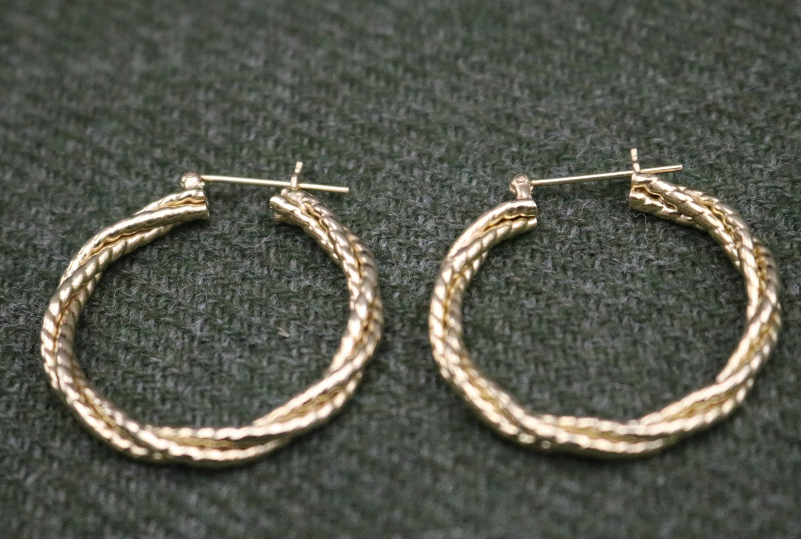 PAIR 14K BRIGHT-POLISHED YELLOW GOLD HOOP EARRINGS - D: 1 1/4". Wt: 3 dwt..: PAIR 14K BRIGHT-POLISHED YELLOW GOLD HOOP EARRINGS Circular hoops constructed of three entwined ropes; post backs. D: 1 1/4". Wt: 3 dwt.