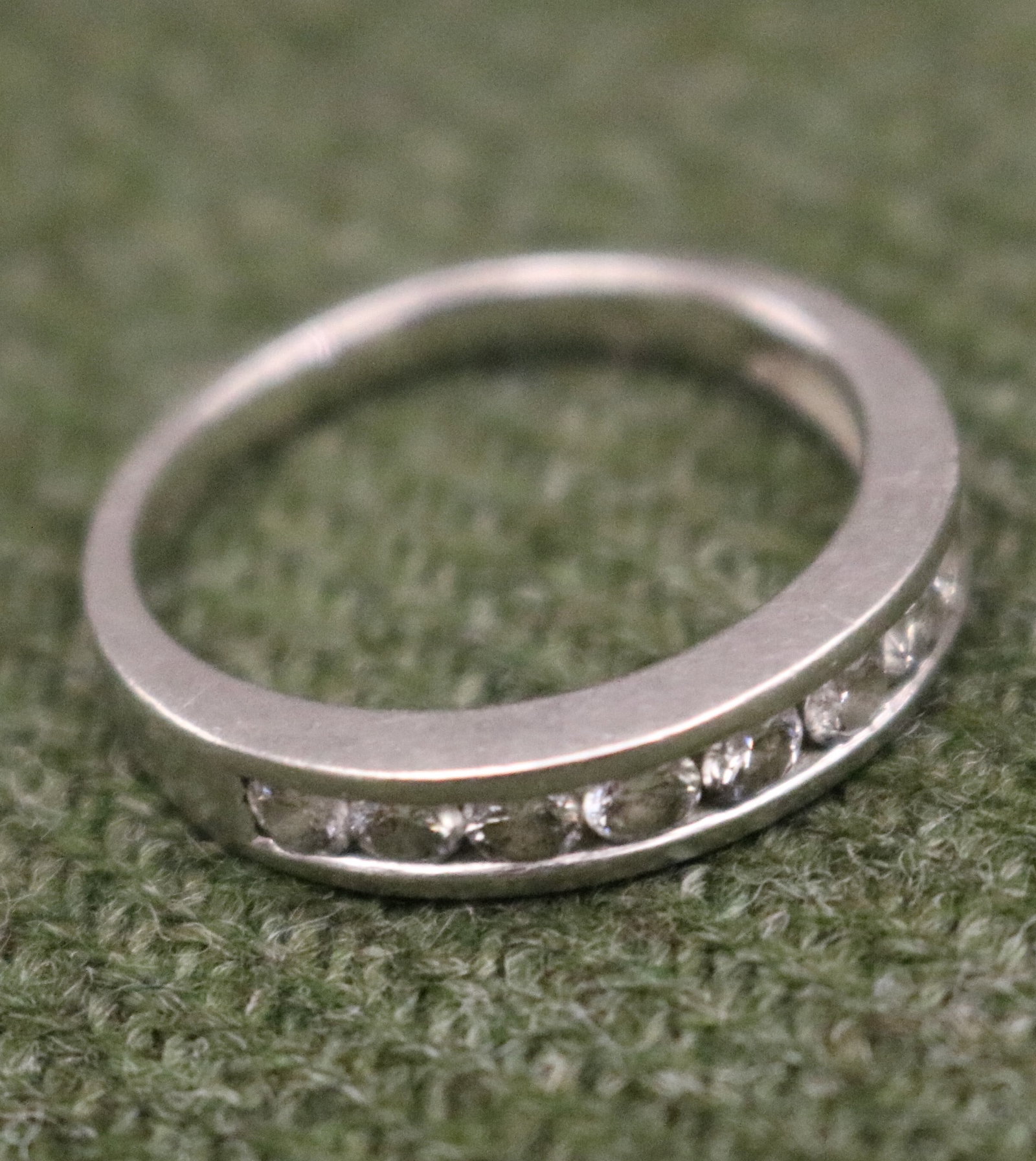 PLATINUM (950-FINE) AND DIAMOND BAND - Ring size: 7 1/4. Gross wt: 3 dwt..: PLATINUM (950-FINE) AND DIAMOND BAND Top section has row of nine matched brilliant-cut round diamonds together weighing approximately .50 ct. Ring size: 7 1/4. Gross wt: 3 dwt.