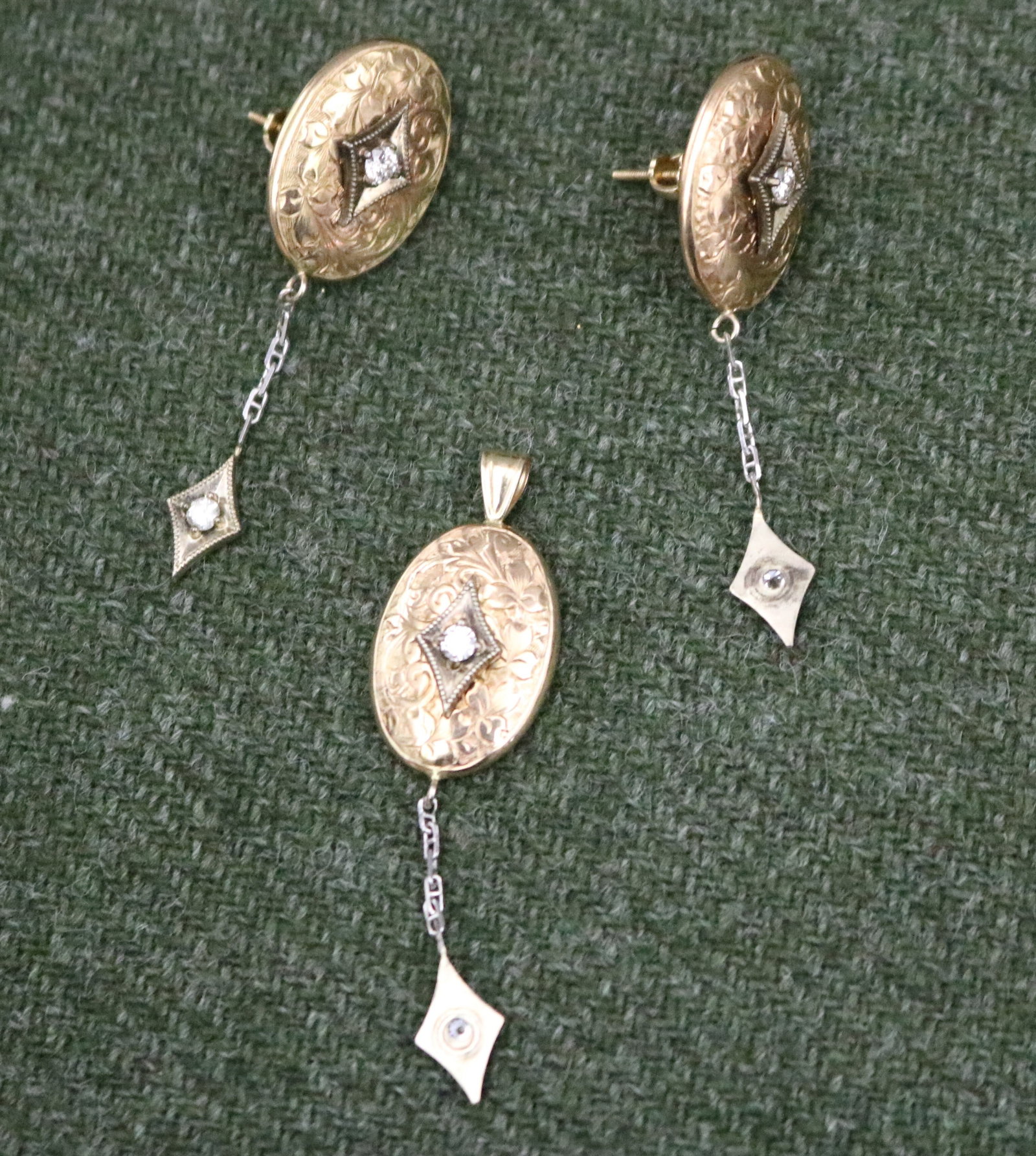 PAIR OF ENGLISH EDWARDIAN 15K (625) YELLOW GOLD AND DIAMOND OVAL DANGLE EARRINGS WITH MATCHING: PAIR OF ENGLISH EDWARDIAN 15K (625) YELLOW GOLD AND DIAMOND OVAL DANGLE EARRINGS WITH MATCHING PENDANT, CONVERTED FROM CUFFLINKS Each with chased scrolling decoration centering brilliant-cut diamond r
