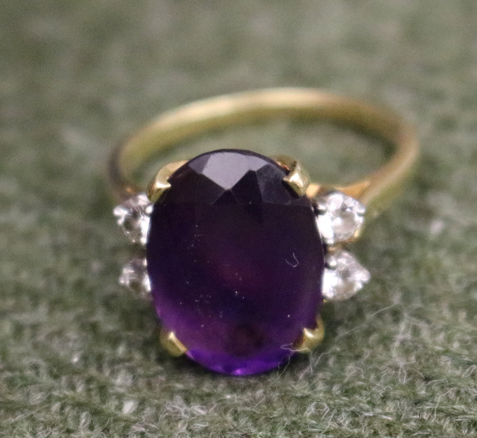 18K YELLOW GOLD, PLATINUM, DIAMOND AND AMETHYST RING - Ring size: 6 1/4. Gross Wt: 3 dwt..: 18K YELLOW GOLD, PLATINUM, DIAMOND AND AMETHYST RING Oval amethyst centered by two pairs of matched, brilliant-cut round diamonds together weighing approximately .30 ct. Ring size: 6 1/4. Gross Wt: 3 