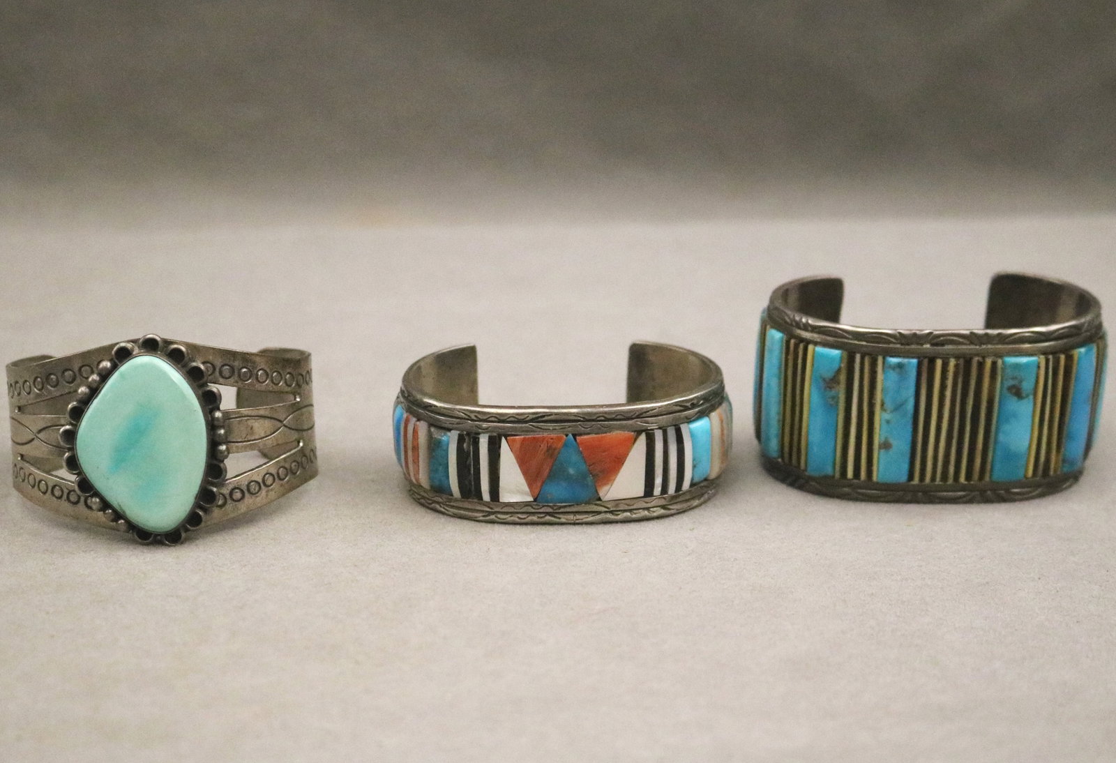 THREE NATIVE AMERICAN SILVER AND VARIOUS HARDSTONE OPEN-END CUFF BRACELETS - Widest, 1 1/2 in. Gross (1 of 5)