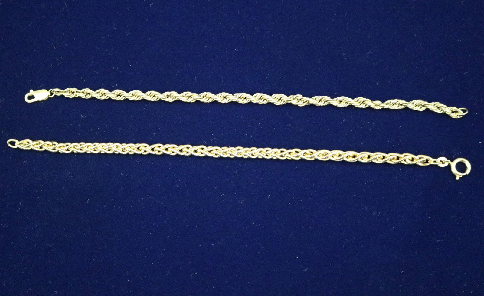 TWO 14K YELLOW GOLD FLEXIBLE-LINK CHAIN BRACELETS - L: 7 1/4" and 7 1/2". Wt: 7 dwt..: TWO 14K YELLOW GOLD FLEXIBLE-LINK CHAIN BRACELETS One, rope design; other, overlapping twisted oval links. L: 7 1/4" and 7 1/2". Wt: 7 dwt.