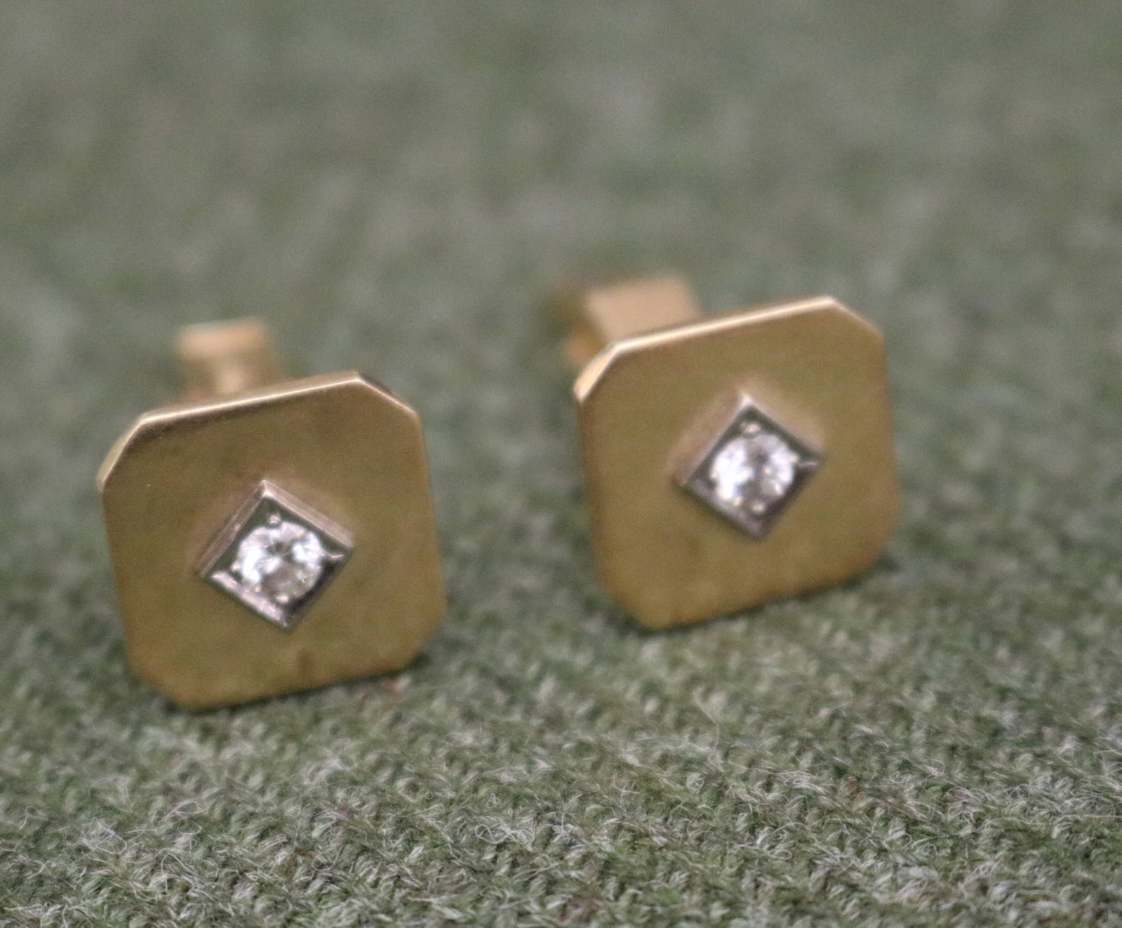 PAIR 14K BRIGHT-POLISHED YELLOW AND WHITE GOLD AND DIAMOND SQUARE WING-BACK CUFFLINKS - Gross wt: 7: PAIR 14K BRIGHT-POLISHED YELLOW AND WHITE GOLD AND DIAMOND SQUARE WING-BACK CUFFLINKS Each flat square panel with canted corners centers brilliant-cut round diamond weighing approximately .20 ct. rais