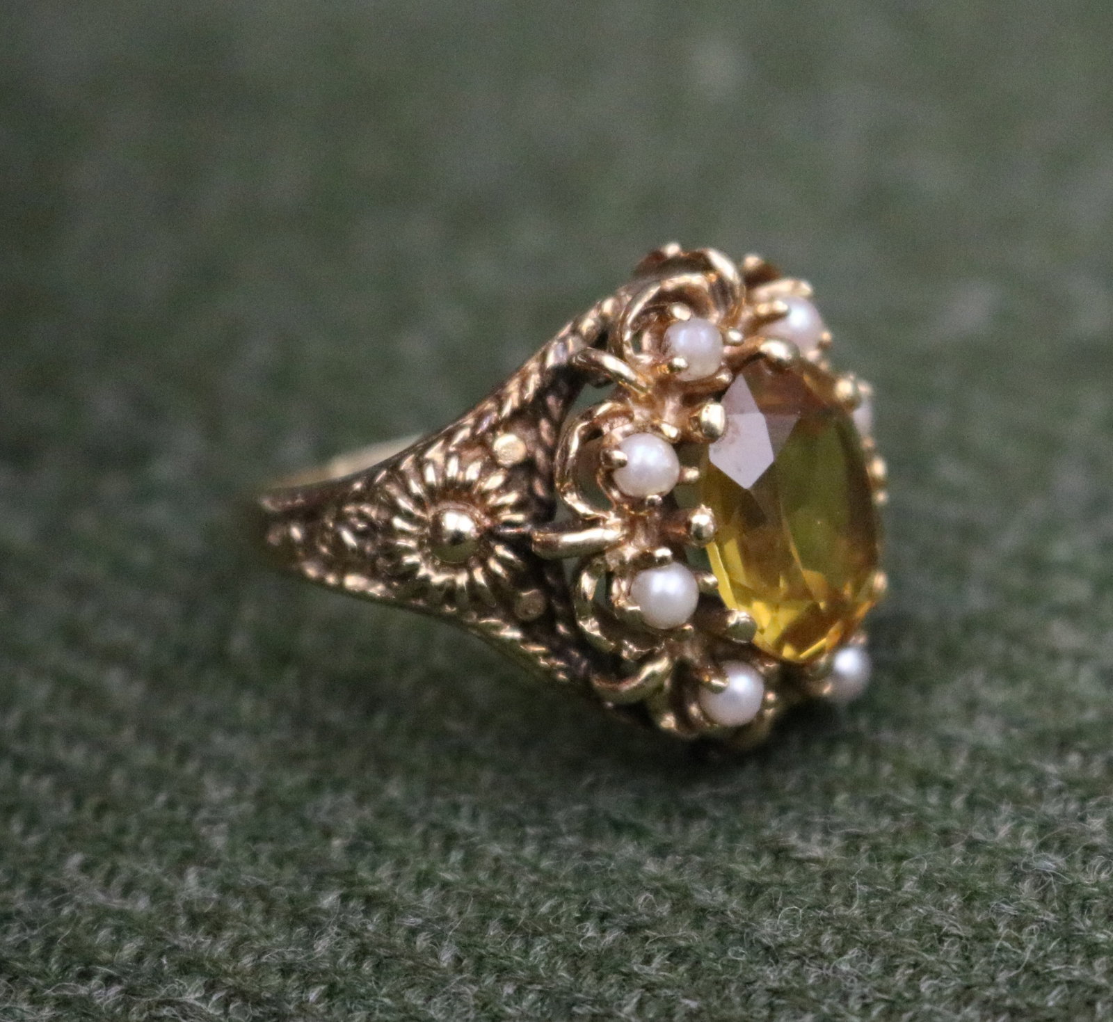 14K YELLOW GOLD, CITRINE AND CULTURED PEARL RING - Ring size: 8 1/2". Gross wt: 8 dwt..: 14K YELLOW GOLD, CITRINE AND CULTURED PEARL RING Prong-held oval pale golden yellow transparent citrine surrounded by eight matched cultured pearls of approximately 3.5mm, in scalloped setting with st