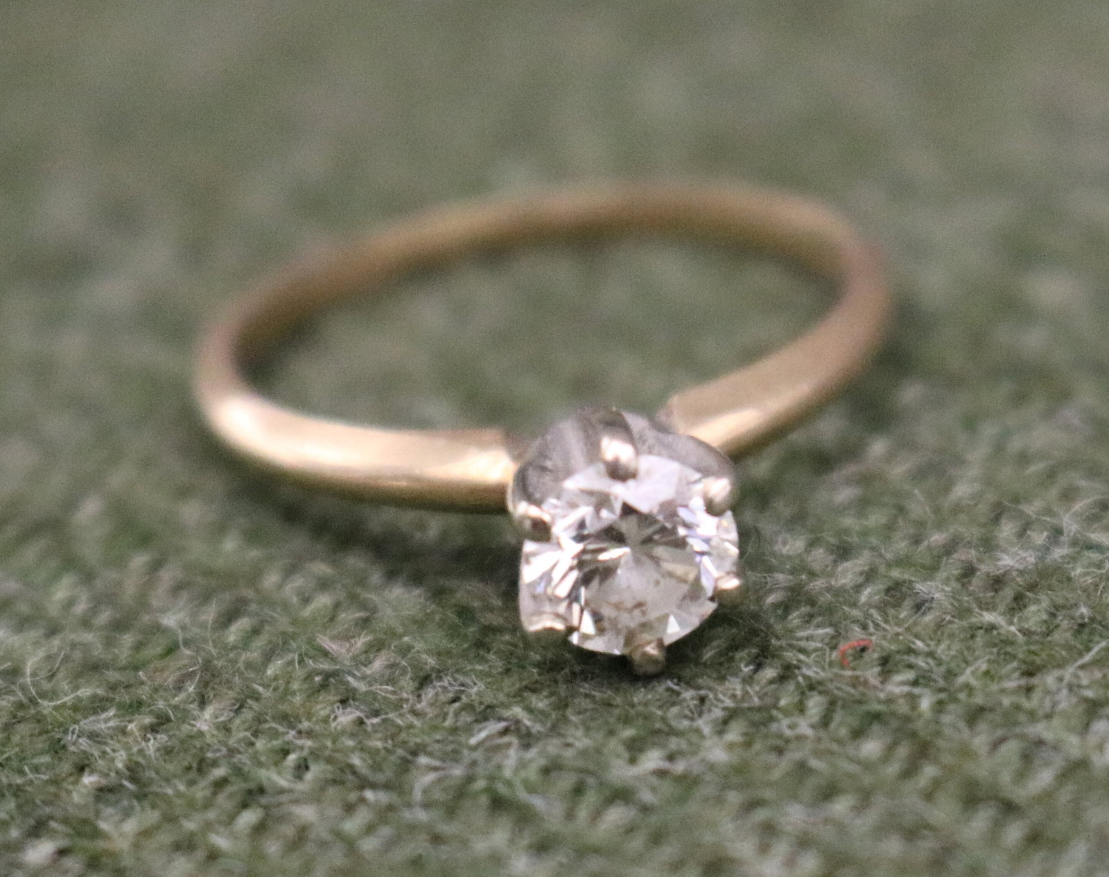14K YELLOW AND WHITE GOLD AND DIAMOND ENGAGEMENT TYPE RING - Ring size: 6 1/2. Gross wt: 3 dwt..: 14K YELLOW AND WHITE GOLD AND DIAMOND ENGAGEMENT TYPE RING Brilliant-cut round diamond weighing approximately .65-70 ct.. raised in six white gold prongs. Ring size: 6 1/2. Gross wt: 3 dwt.