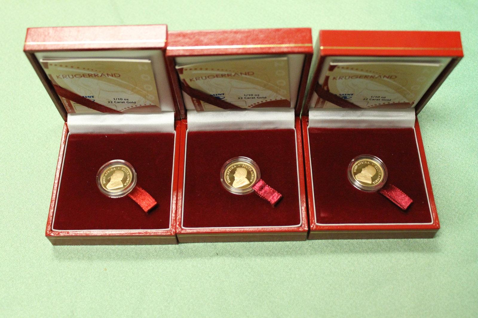 THREE SOUTH AFRICAN 22K GOLD PROOF FRACTIONAL KRUGERRANDS - .: THREE SOUTH AFRICAN 22K GOLD PROOF FRACTIONAL KRUGERRANDS 1/10 oz. each. In individual red presentation cases