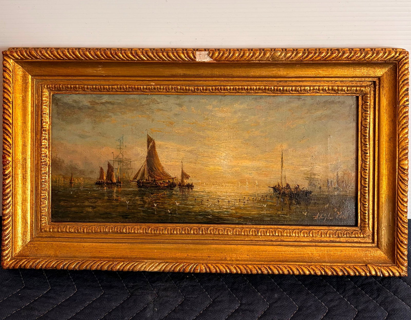 WILLIAM ADOLPHUS KNELL (English, 1801-1975). Fishing Fleet at Sunset, Oil on canvas, 5.5 x 12 inches: WILLIAM ADOLPHUS KNELL English, 1801-1975 Fishing Fleet at Sunset Oil on canvas Signed lower right. Marine oil painting depicts a fleet of fishing sailboats and barges at anchor on calm harbor waters 