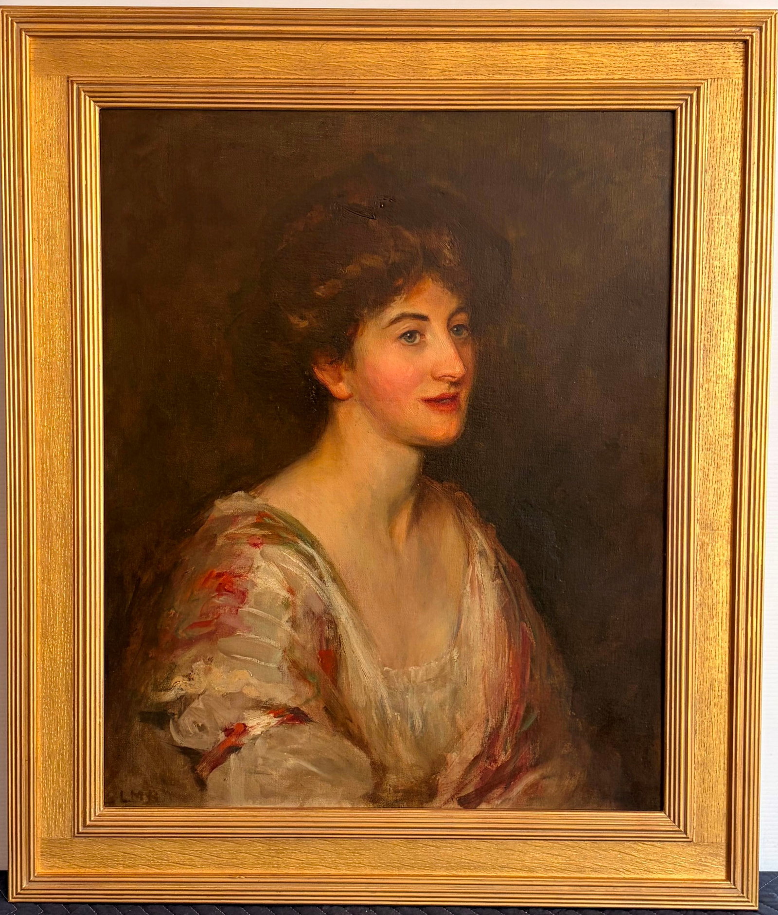 LILIAN MARY REYNOLDS (English, 1864 - 1952). Portrait of a Lady, Oil on canvas, 27 x 22 inches (33?: LILIAN MARY REYNOLDS English, 1864 - 1952 Portrait of a Lady Oil on canvas Artwork initialed "L.M.R." in the lower left; it depicts a fashionable young woman with upswept auburn hair turning gracefull