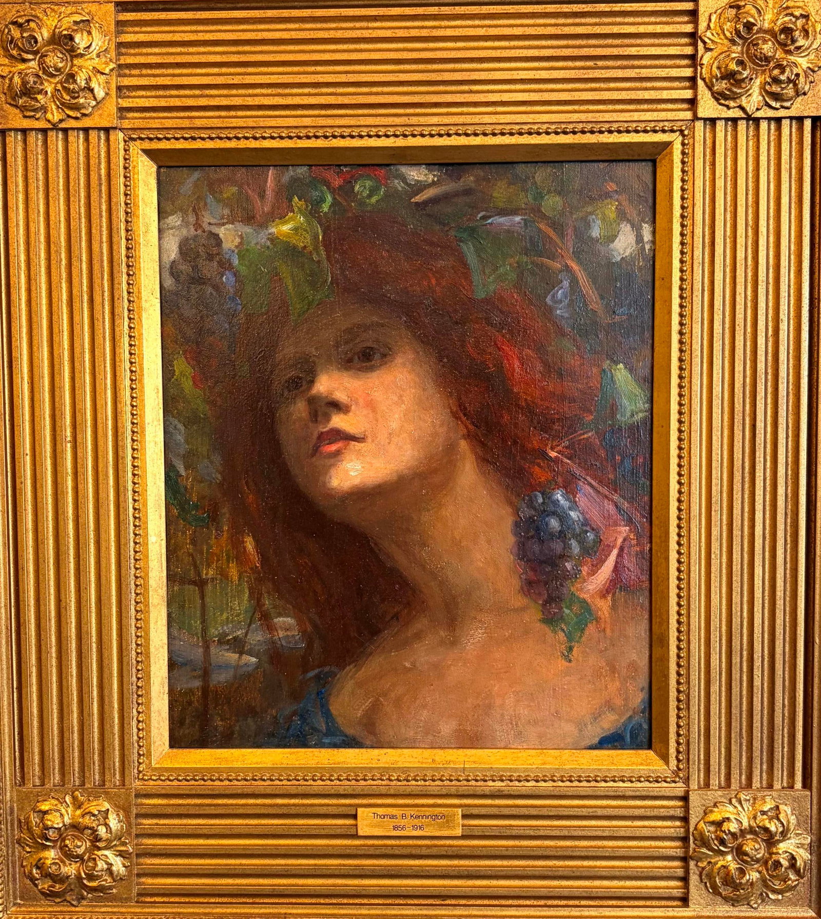 THOMAS BENJAMIN KENNINGTON (British, 1856-1916). Girl with Grapes, Oil on board, 12.5 x 10.5 inches;: THOMAS BENJAMIN KENNINGTON British, 1856-1916 Girl with Grapes Oil on board An oil portrait that depicts a young Bacchic figure with tumbling auburn hair, her head crowned with grape clusters and vine