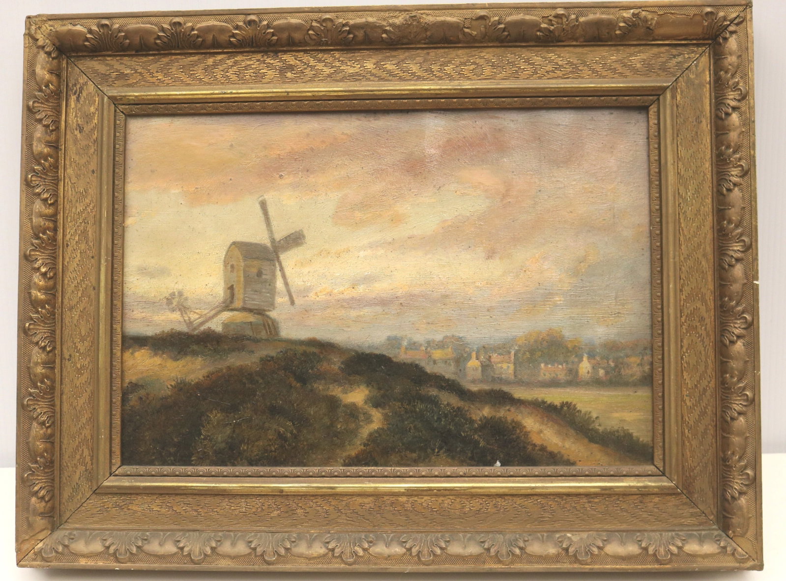 CONTINENTAL SCHOOL (19th century). Windmill at Dusk Overlooking the Town, Oil on board., 11 x 15.5: CONTINENTAL SCHOOL 19th century Windmill at Dusk Overlooking the Town Oil on board. Unsigned. Artwork rendered in a tonalist style, this landscape depicts a solitary post windmill perched atop a grass