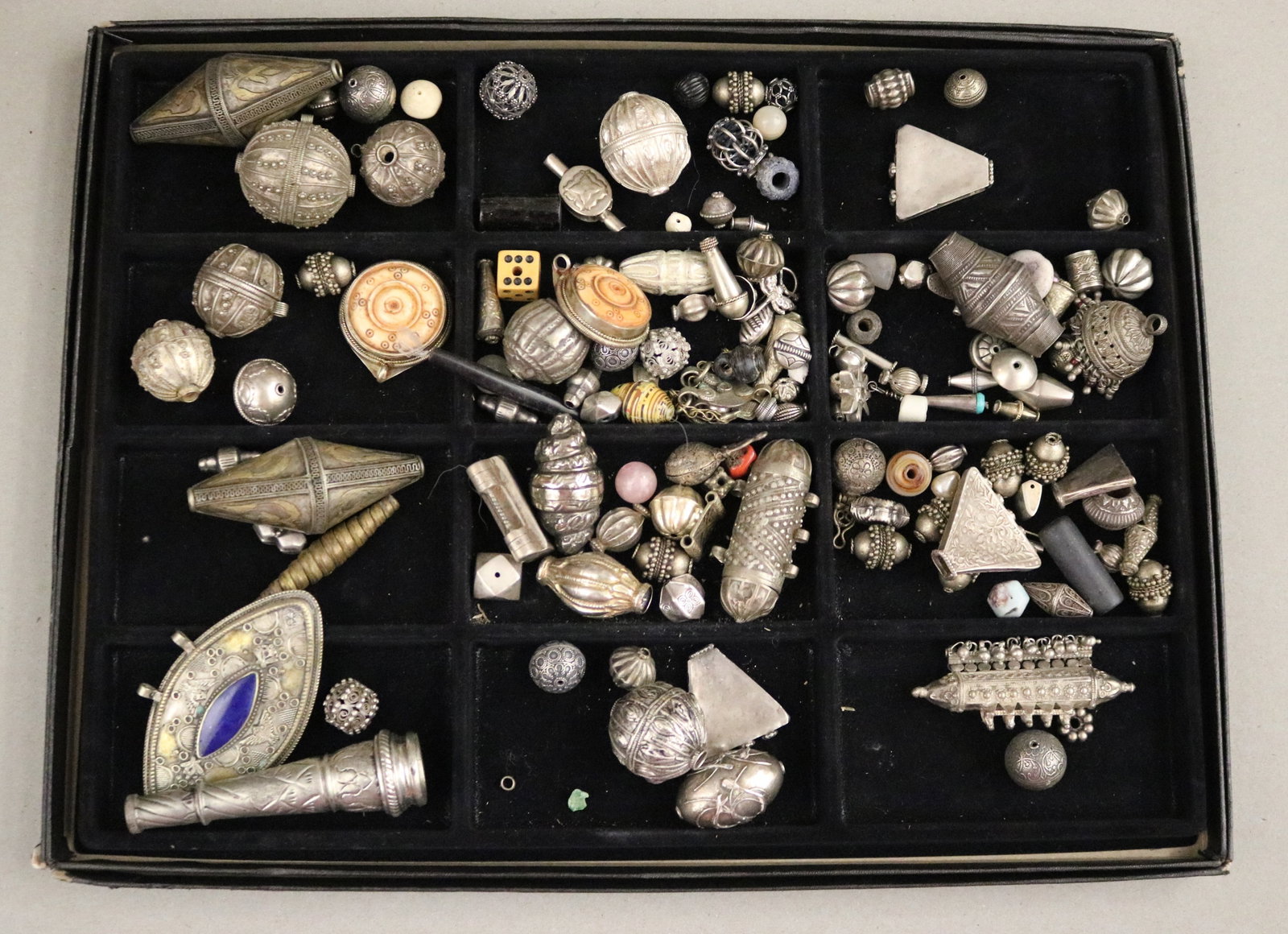 COLLECTION OF SILVER-TONE TRIBAL AMULET BEADS, FILIGREE BEADS & AMULET PENDANTS SET WITH LAPIS,: COLLECTION OF SILVER-TONE TRIBAL AMULET BEADS, FILIGREE BEADS & AMULET PENDANTS SET WITH LAPIS, JEWELRY MAKER'S STUDIO A large lot of silver-tone ethnic metal beads, pendants, and amulet components fr