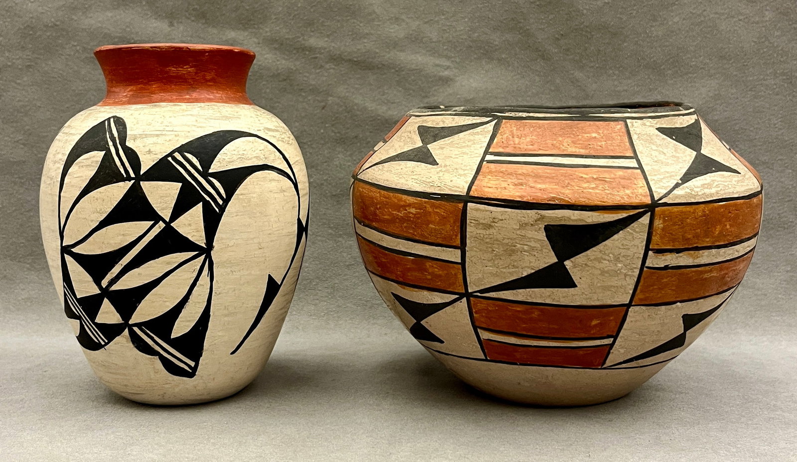 TWO ACOMA PUEBLO POTTERY VESSELS, INCLUDING ONE SIGNED JAY VALLO - height (approx.) 6 inches.: TWO ACOMA PUEBLO POTTERY VESSELS, INCLUDING ONE SIGNED JAY VALLO A pair of hand-painted Acoma Pueblo pottery vessels: the taller ovoid jar signed "Acoma, N. Mex. J. Vallo" on its base, decorated with 