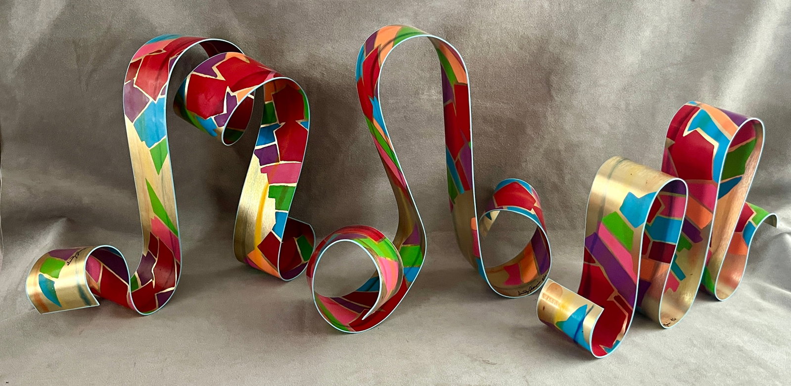 DOROTHY GILLESPIE (American, 1920?2012). RIBBON SCULPTURE, Mixed media on metal, Each section is: DOROTHY GILLESPIE American, 1920?2012 RIBBON SCULPTURE Mixed media on metal A dynamic hand-painted aluminum ribbon sculpture signed "Dorothy Gillespie" and numbered 8 of an edition of 10; its looping,