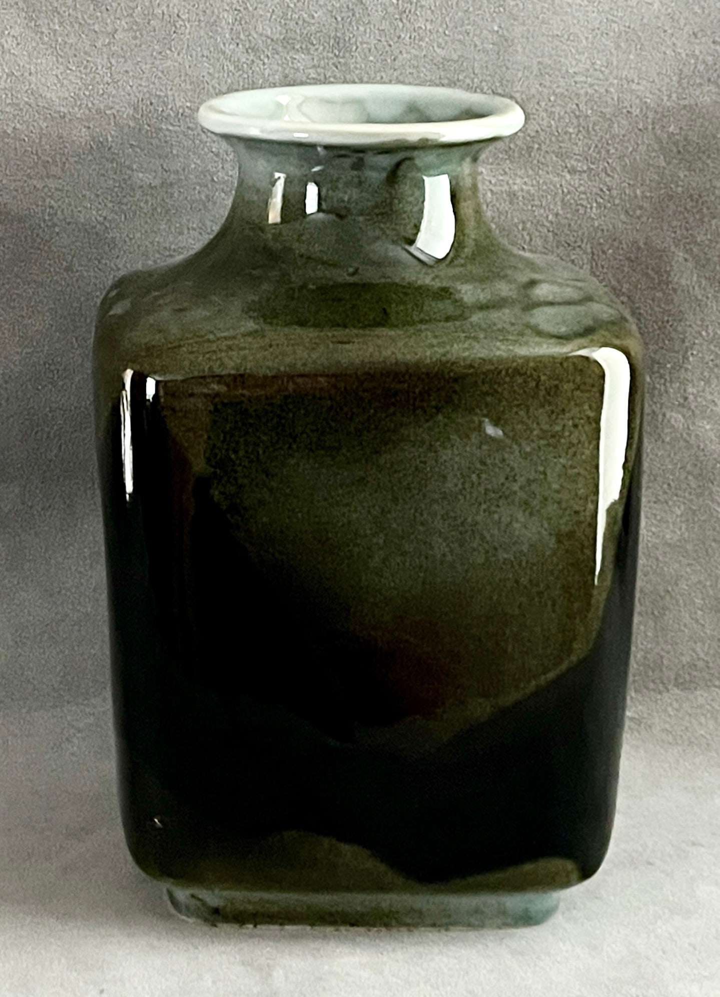 FANCE FRANCK (American, 1931-2008 .). GLAZED STONEWARE VASE, "DARK CLOWN", Glazed stoneware, Height:: FANCE FRANCK American, 1931-2008 . GLAZED STONEWARE VASE, "DARK CLOWN" Glazed stoneware Rectangular stoneware vase that is squared and with a cushioned body rising to a flared celadon-glazed neck and 
