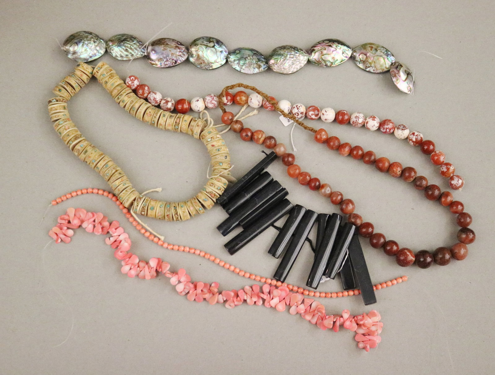 COLLECTION OF SHELL, CORAL & STONE BEADING STRANDS; JEWELRY MAKER'S STUDIO - .: COLLECTION OF SHELL, CORAL & STONE BEADING STRANDS; JEWELRY MAKER'S STUDIO Lot of loose beading strands featuring shell, coral, and natural stone materials from a jewelry maker's studio. Approximate q