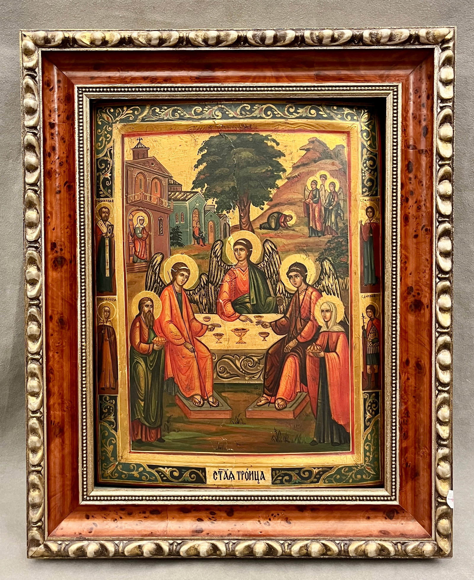 RUSSIAN ICON OF THE HOLY TRINITY (HOSPITALITY OF ABRAHAM) 20th century - 15.5 x 11.5 inches; frame:: RUSSIAN ICON OF THE HOLY TRINITY (HOSPITALITY OF ABRAHAM) 20th century Eastern Orthodox icon depicting the Holy Trinity centered on three winged angels at the table beneath the Oak of Mamre, detailed 