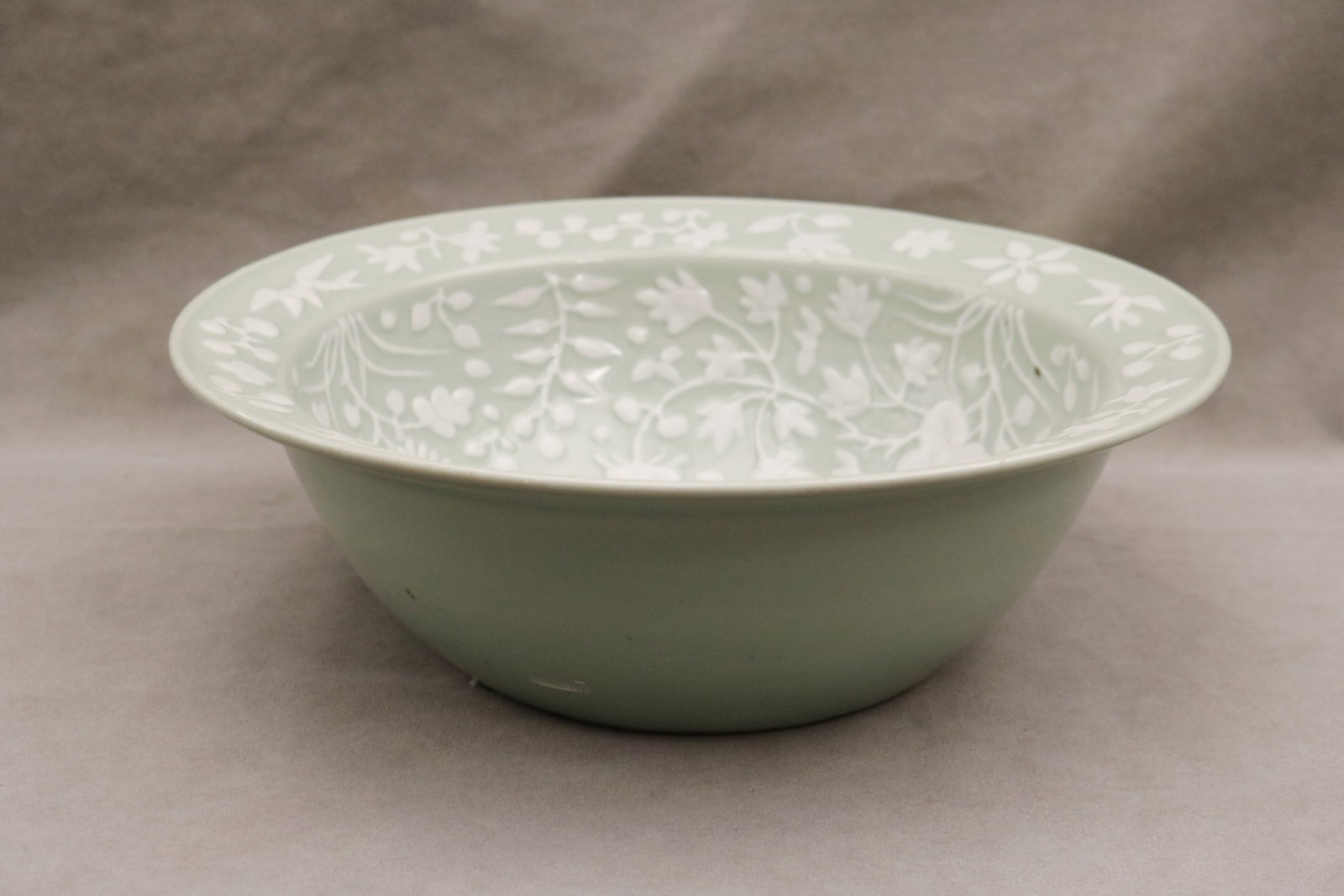 CHINESE CELADON GLAZED PORCELAIN BASIN Ching Dynasty, circa 1890 - D: 13 1/2 in..: CHINESE CELADON GLAZED PORCELAIN BASIN Ching Dynasty, circa 1890 Interior has relief floral decoration with white glaze D: 13 1/2 in.