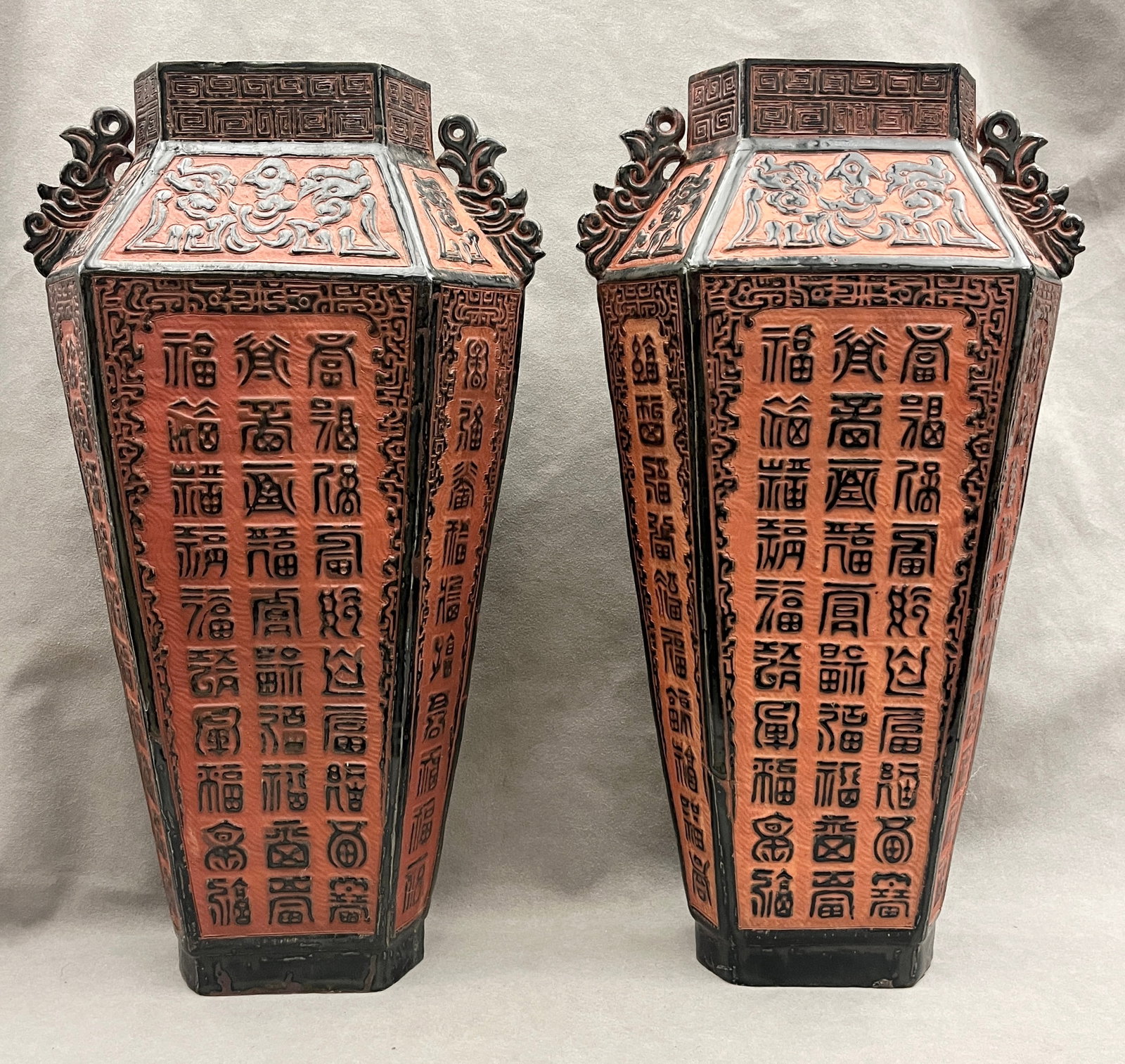 PAIR OF CHINESE ARCHAISTIC SEAL-SCRIPT FU-CHARACTER TERRACOTTA VASES - H: 19 1/2 in..: PAIR OF CHINESE ARCHAISTIC SEAL-SCRIPT FU-CHARACTER TERRACOTTA VASES Hexagonally-faceted vases with glazed body and dark black-brown trim, each panel decorated with vertical columns of repeated archai