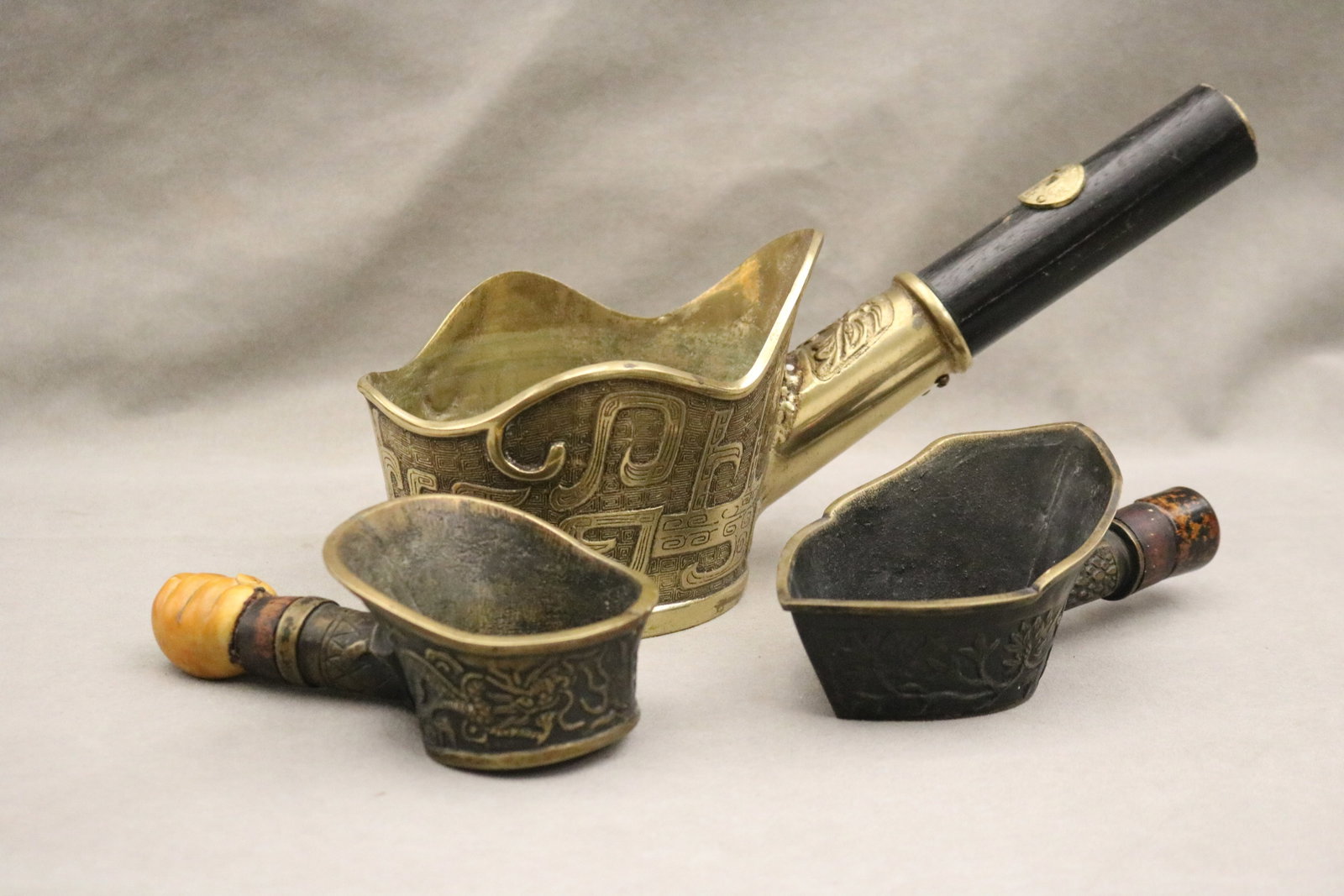 THREE ASSORTED CHINESE IRONS CAST WITH RELIEF DECORATION - Largest, L; 13 in..: THREE ASSORTED CHINESE IRONS CAST WITH RELIEF DECORATION Largest, L; 13 in.