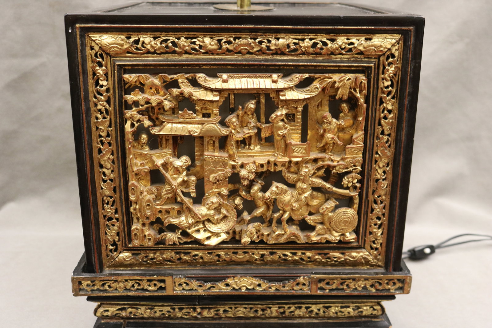 CHINESE CARVED AND GILT WOOD OPENWORK CUBE-FORM TABLE LAMP - Base, H: 14 in..: CHINESE CARVED AND GILT WOOD OPENWORK CUBE-FORM TABLE LAMP Panels of gilt figures in pavilions Base, H: 14 in.