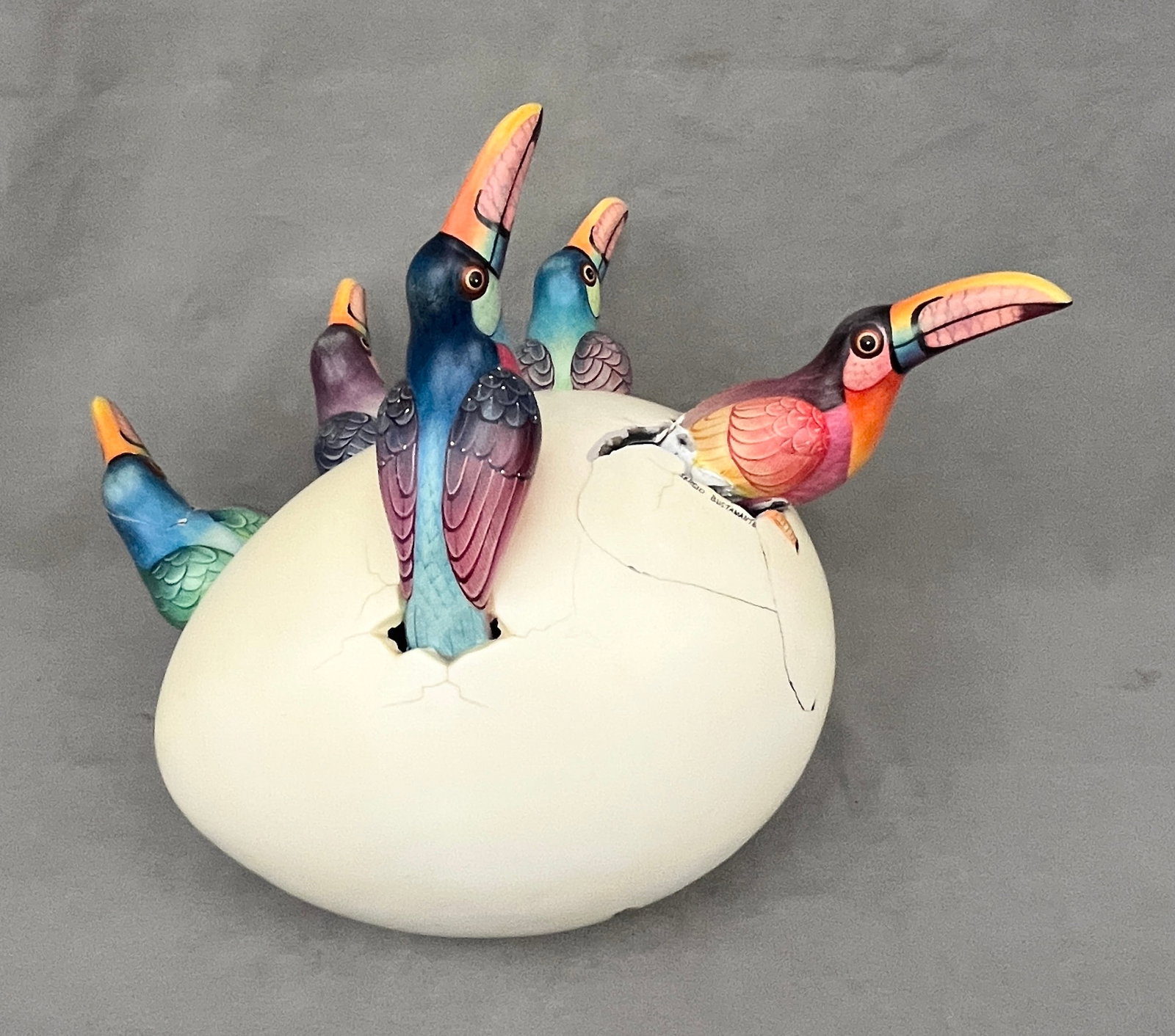 SERGIO BUSTAMANTE (Mexican, b. 1949). FIVE TOUCAN BIRDS EMERGING FROM EGG, H: 14 in. (1 of 8)