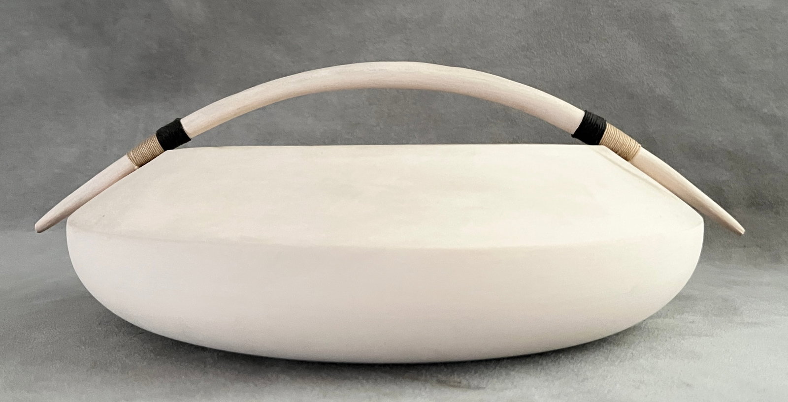 TWO SIGNED CONTEMPORARY ARTISTAN-CRAFTED POTTERY VESSELS - .: TWO SIGNED CONTEMPORARY ARTISTAN-CRAFTED POTTERY VESSELS One, white matte-finish bowl with low crescent handle signed, D: 9 1/4 in.; other, two-handle urn-form terracotta, H: 10 1/2 in. With monograms