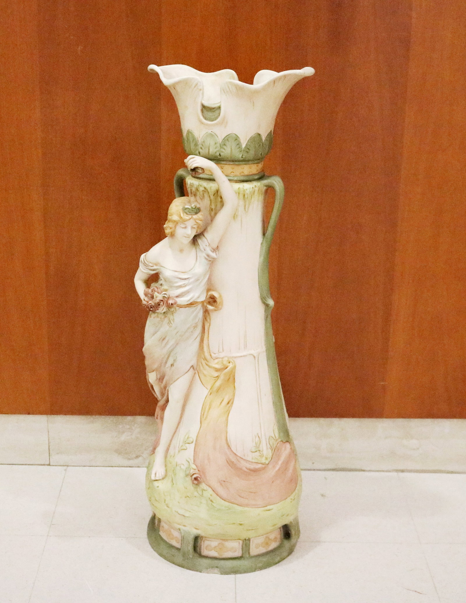 ART NOUVEAU BOHEMIAN FIGURAL DECORATED BISQUE PORCELAIN VASE, POSSIBLY ROYAL DUX late 19th century -: ART NOUVEAU BOHEMIAN FIGURAL DECORATED BISQUE PORCELAIN VASE, POSSIBLY ROYAL DUX late 19th century High-relief female figure, pastel polychrome glaze, and flared, ruffled rim H: 29 3/4 in.