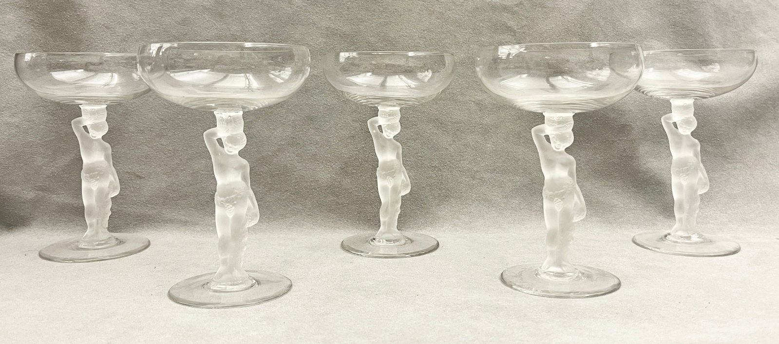 SET OF FIVE BAYEL FRENCH FROSTED NUDE FIGURAL CHAMPAGNE COUPES - .: SET OF FIVE BAYEL FRENCH FROSTED NUDE FIGURAL CHAMPAGNE COUPES Set of five crystal champagne coupes by Bayel, France, each with a clear glass bowl raised on a frosted stem modeled as a standing nude m