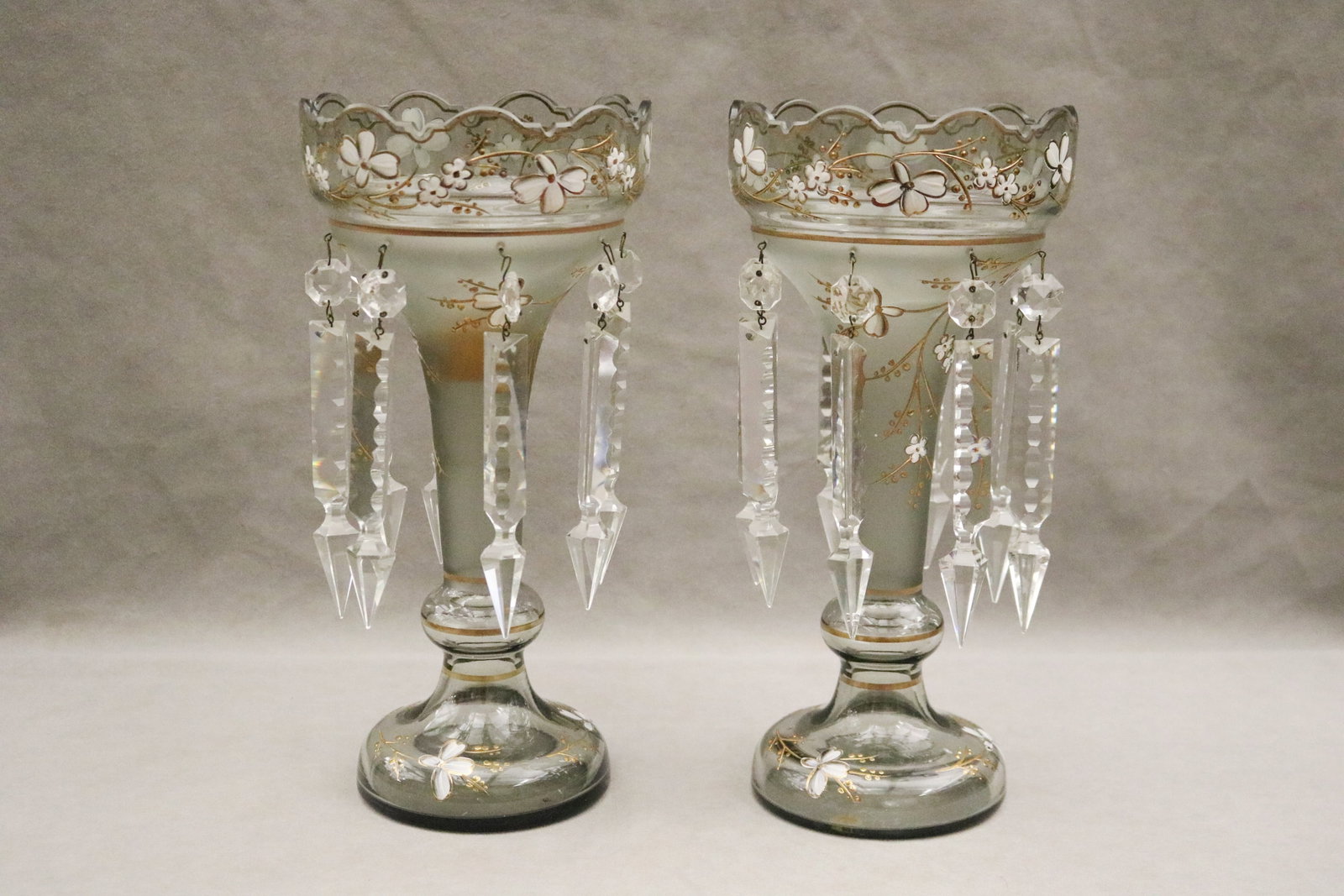 PAIR FLORAL-PAINTED GLASS LUSTER CANDLESTICKS - H: 12 1/2 in..: PAIR FLORAL-PAINTED GLASS LUSTER CANDLESTICKS White enamel and gilt blossoms. Suspending cut colorless crystal Price Albert points. H: 12 1/2 in.