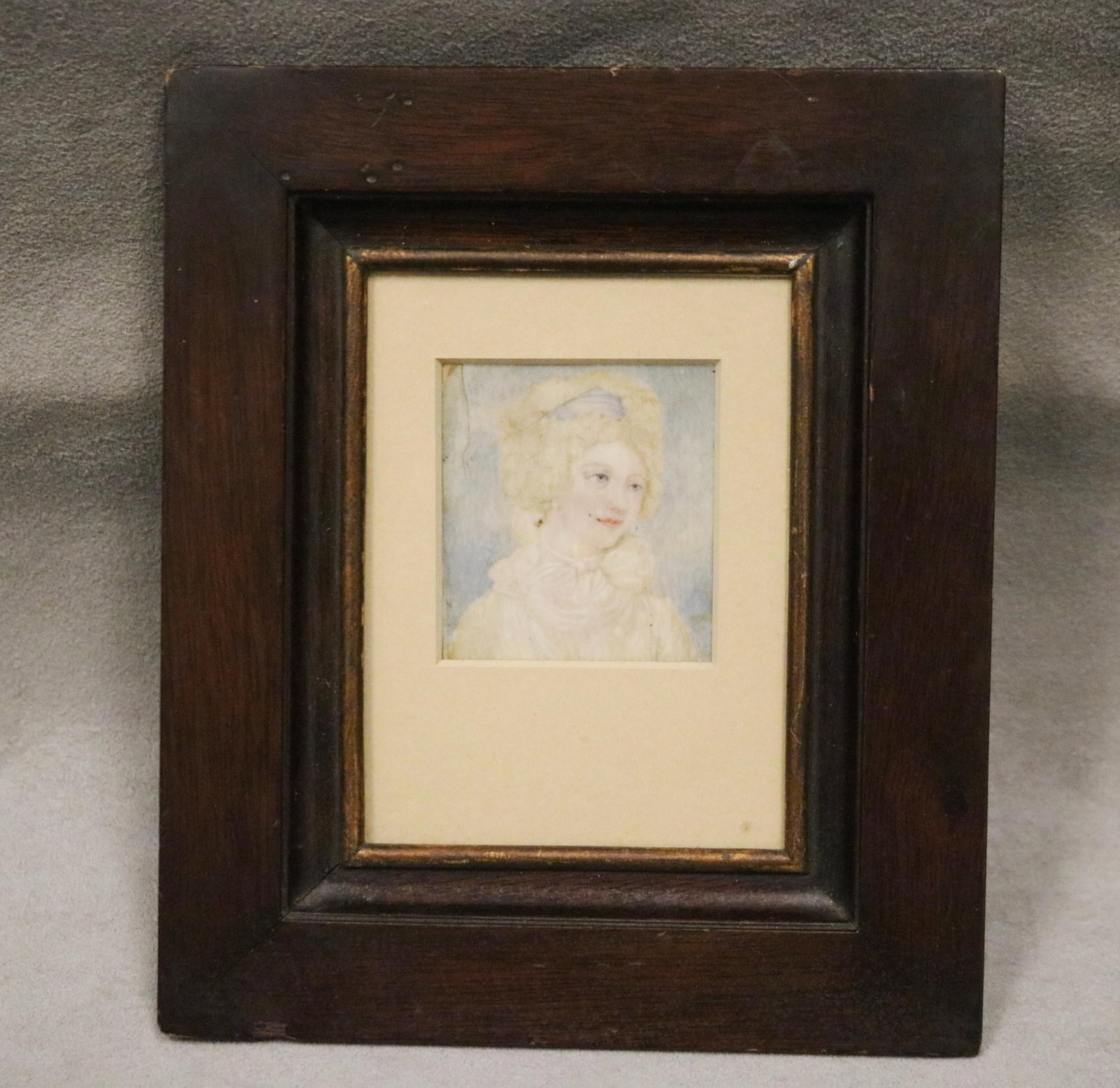 FRENCH ARTIST UNKNOWN (early 19th century). PORTRAIT OF LADY IN WHITE DRESS WITH BLUE RIBBON IN: FRENCH ARTIST UNKNOWN early 19th century PORTRAIT OF LADY IN WHITE DRESS WITH BLUE RIBBON IN HAIR Miniature watercolor. 19th century mahogany frame. Sight size as matted; 2 in. x 1 3/4 in.